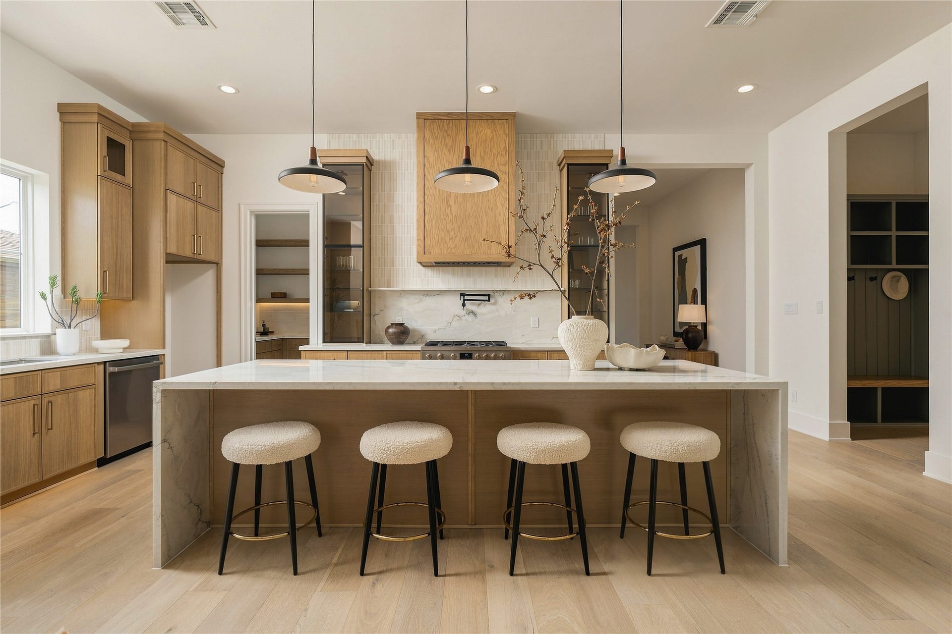 2109 McKean Drive, Houston, TX 77080 A front-facing view highlights the kitchens symmetry and tailored composition, with the oversized island anchoring the space and seating five comfortably for casual dining and conversation.