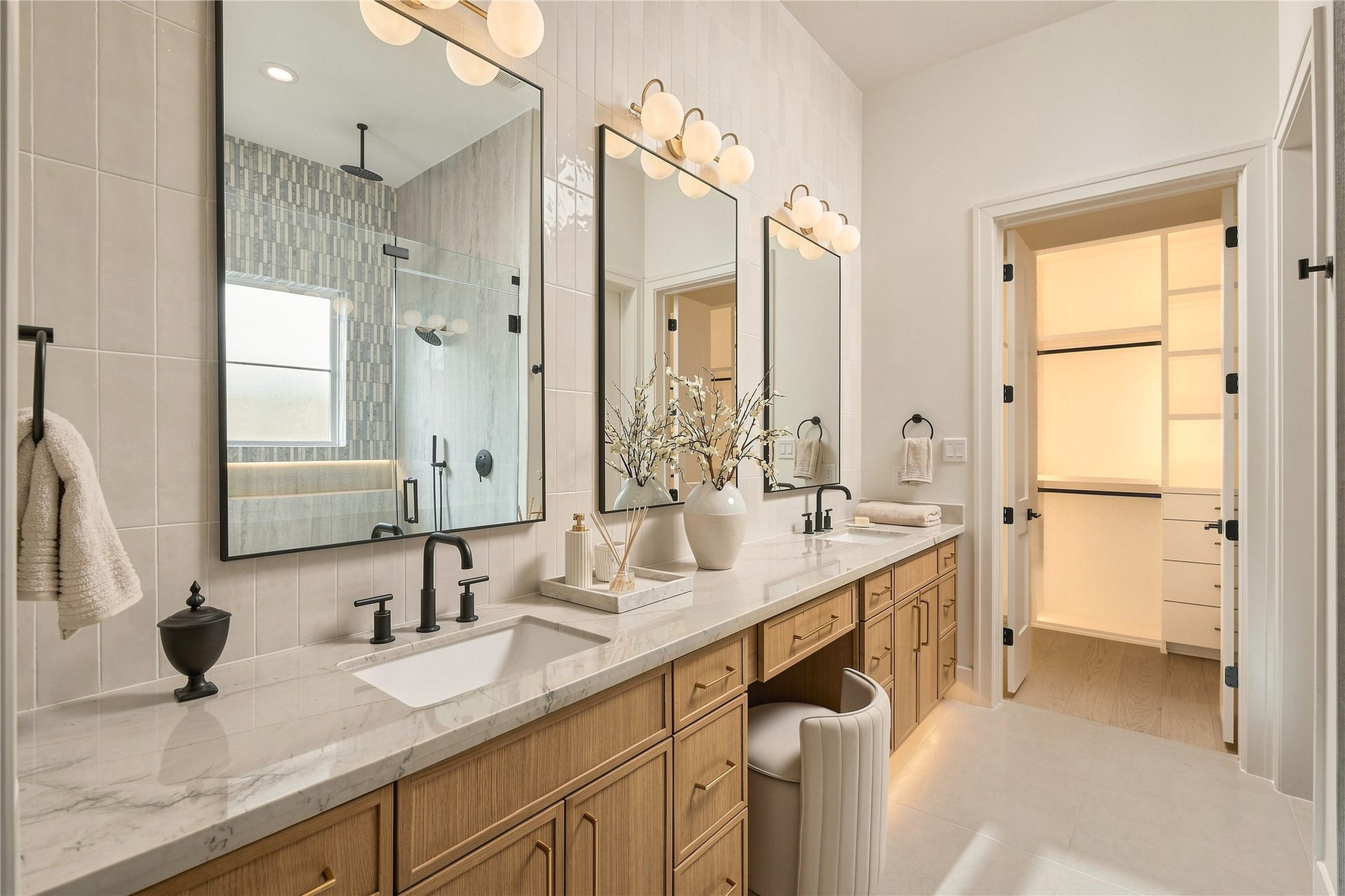 2109 McKean Drive, Houston, TX 77080 A closer look at the primary vanity showcases Mount Blanc Quartzite countertops, abundant storage, and a dedicated makeup station, with direct access to one of the suites two custom closets.
