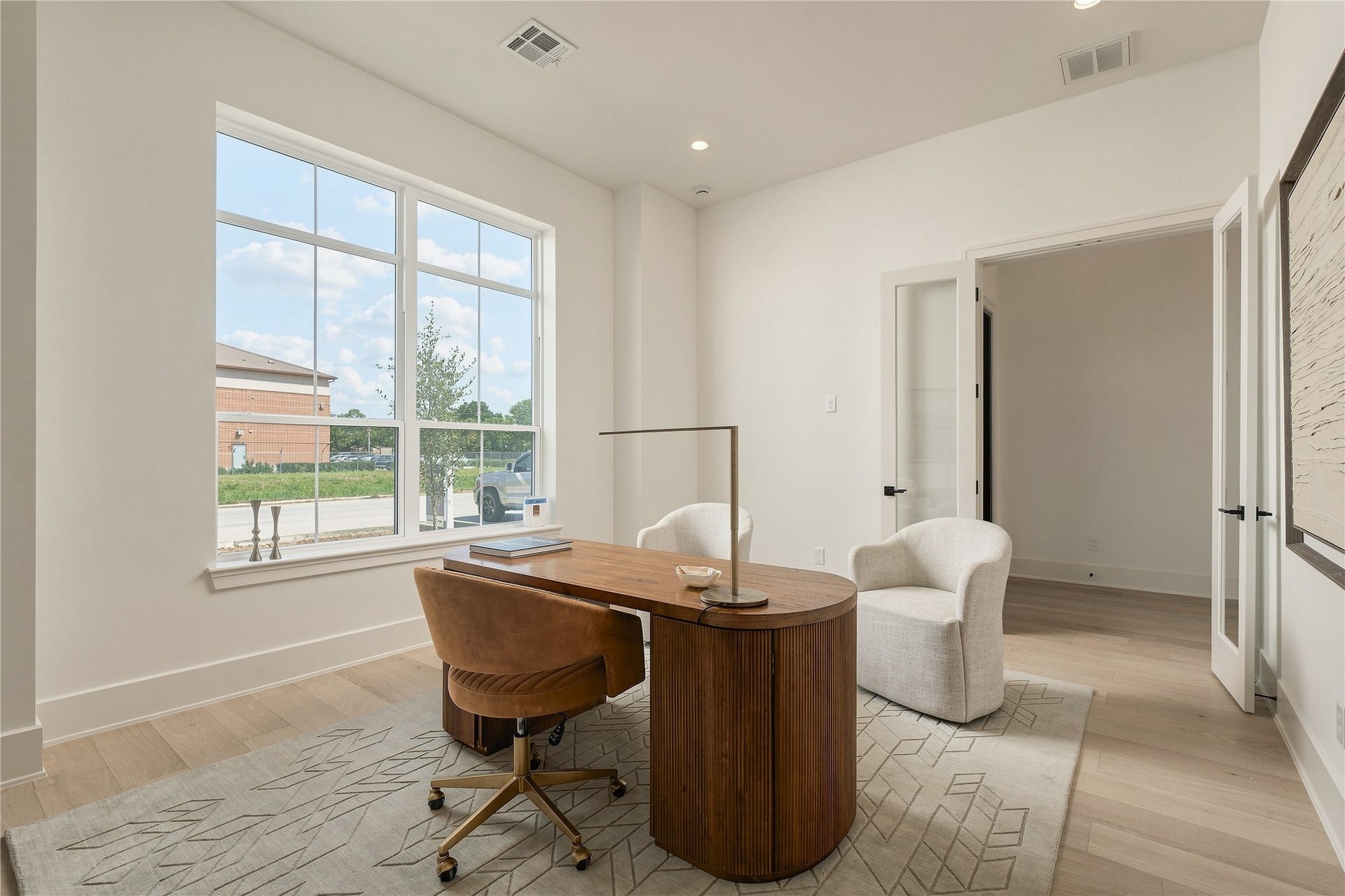 2109 McKean Drive, Houston, TX 77080 The home office balances privacy with openness, featuring generous proportions and oversized windows that bring natural light into the workspace.