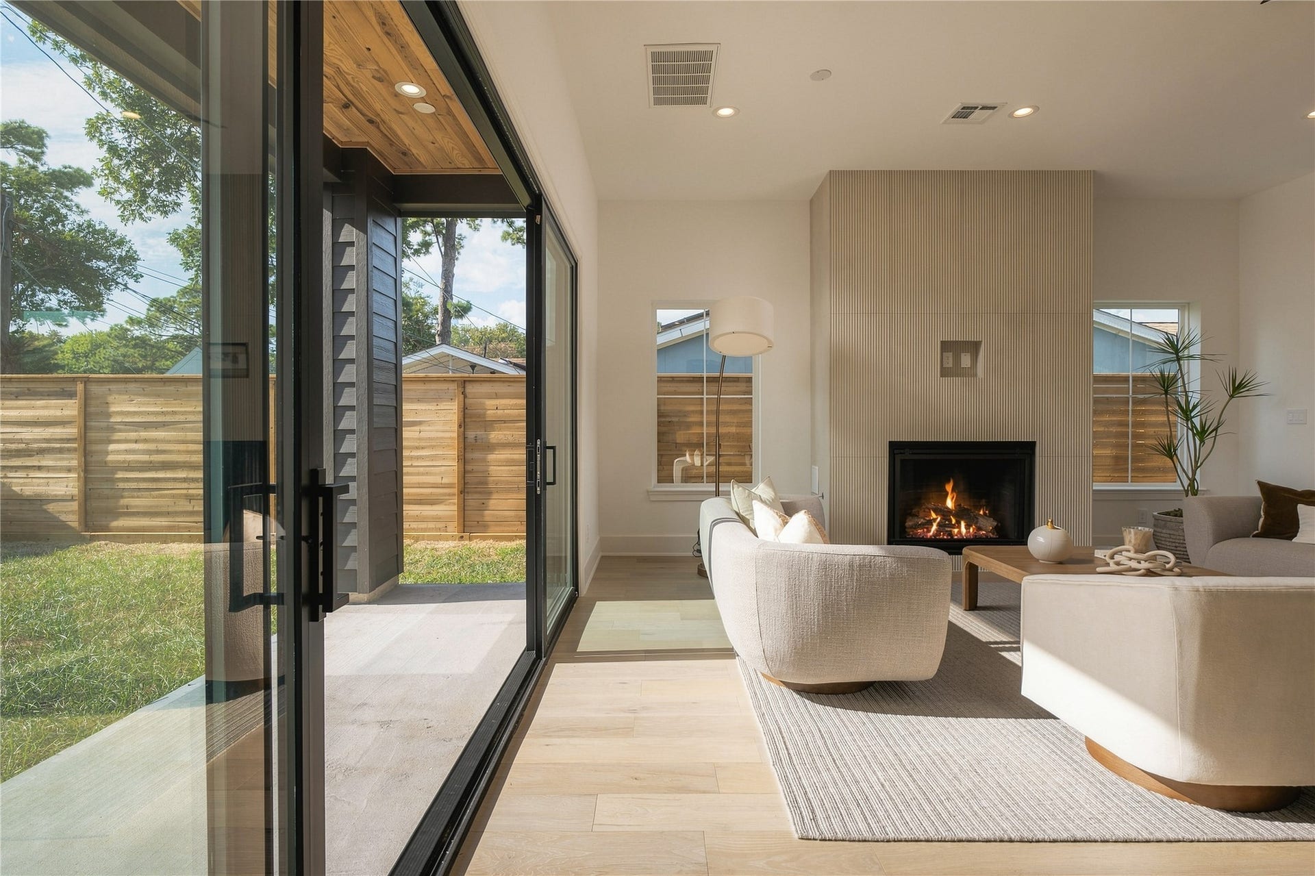2109 McKean Drive, Houston, TX 77080 Expansive 16-foot Pella sliding doors blur the line between indoors and out, filling the living space with natural light and opening directly to the covered patio and oversized backyard.
