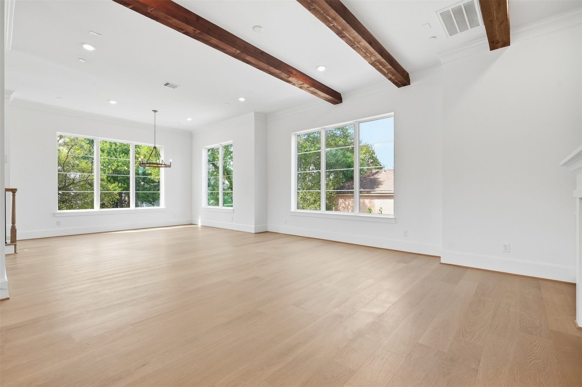 2111 Nantucket Drive, #D, Houston, TX 77057 The open-concept living, dining, and kitchen spaces come together beneath striking real cedar beams, bringing warmth and character to the heart of the home.