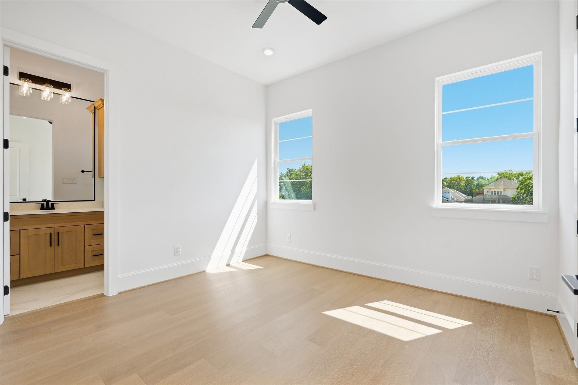 2111 Nantucket Drive, #D, Houston, TX 77057 This secondary bedroom is filled with natural light and includes direct access to a private en-suite bath.