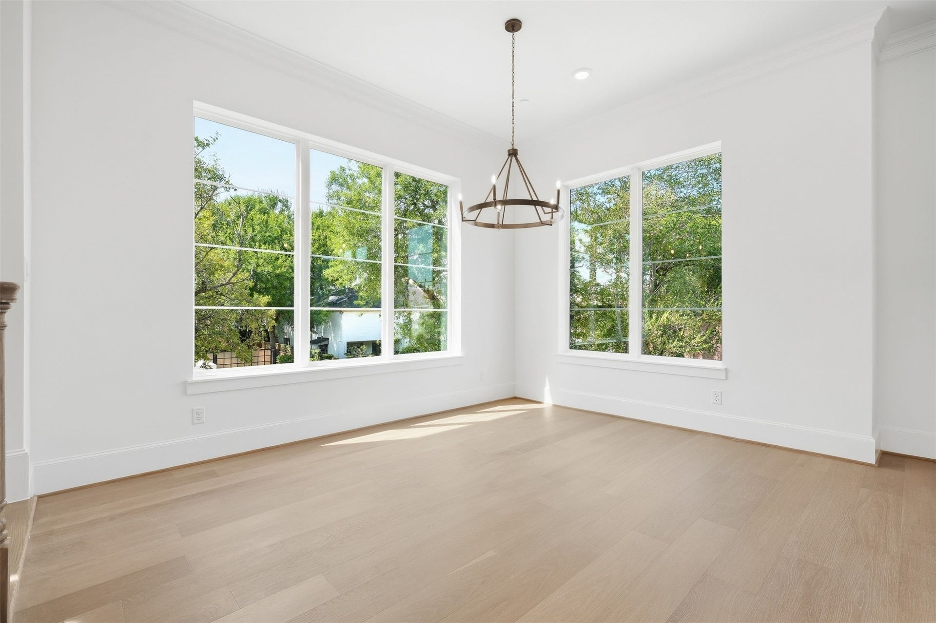 2111 Nantucket Drive, #D, Houston, TX 77057 **Photo 2 Dining Room**
The dining area sits at the heart of the open-concept living space, featuring a statement chandelier, wide-plank flooring, and an easy flow into the living room and kitchen.