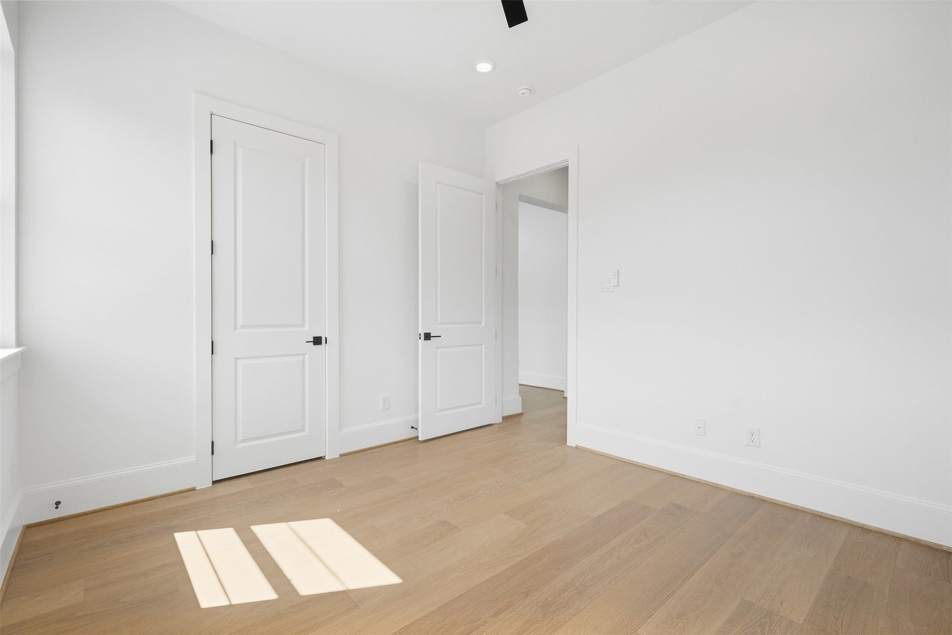 2111 Nantucket Drive, #D, Houston, TX 77057 A bright secondary bedroom offers wide plank flooring, recessed lighting, and a clean, versatile layout.