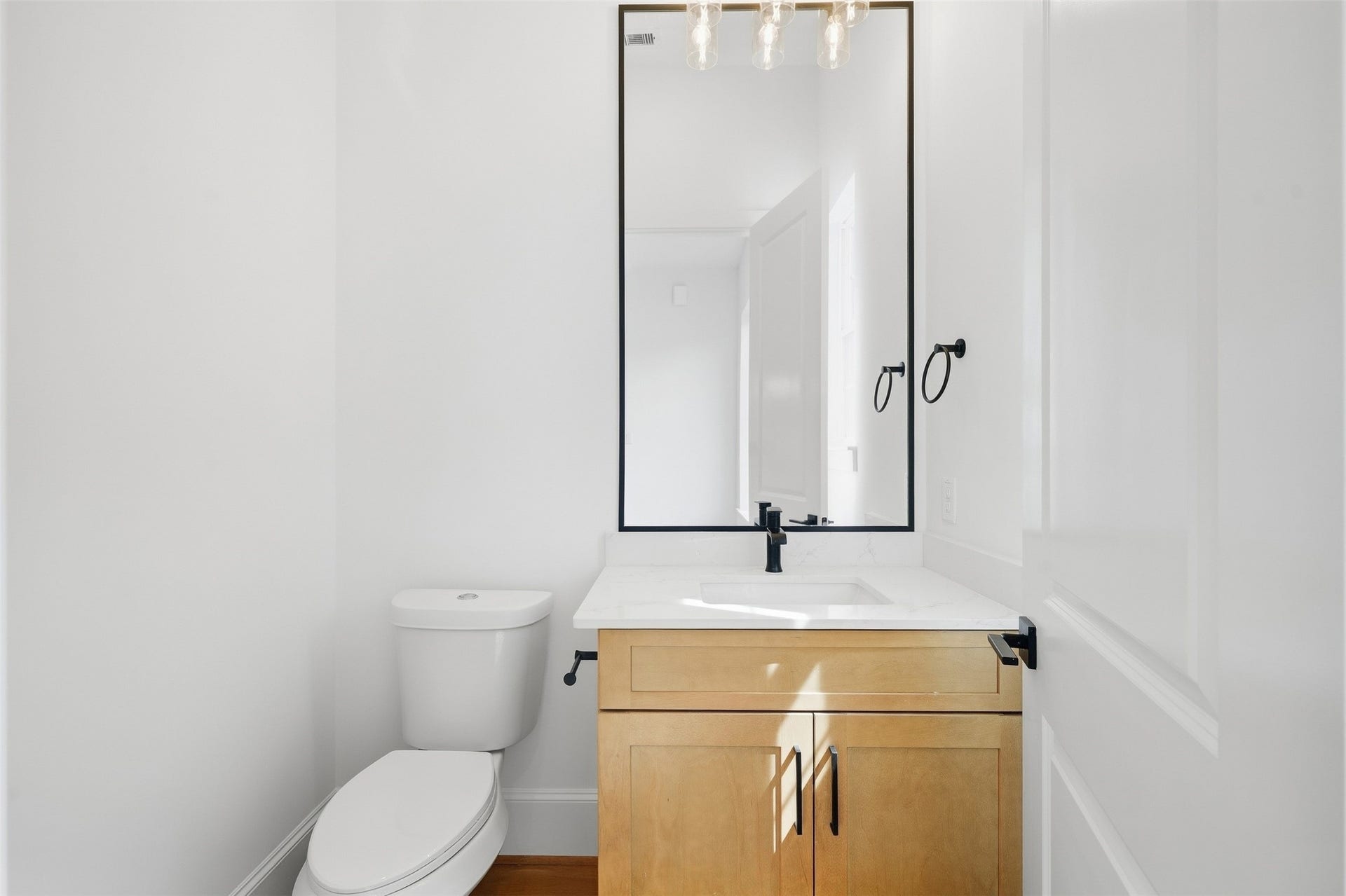 2111 Nantucket Drive, #D, Houston, TX 77057 A stylish powder bath adds convenience for guests while carrying the home's cohesive finishes throughout.