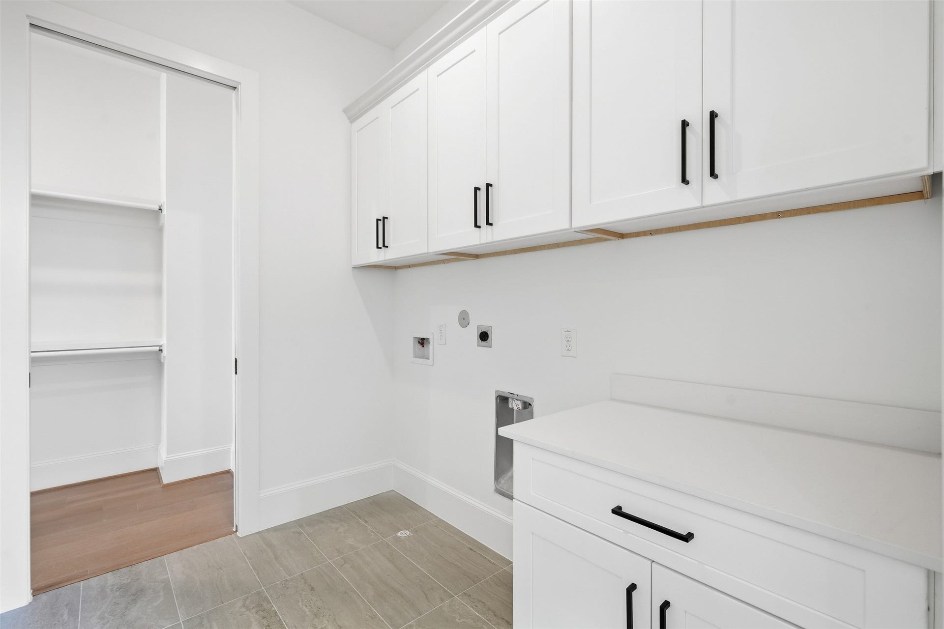 2111 Nantucket Drive, #D, Houston, TX 77057 The utility room offers abundant cabinetry, counter space, and convenient access to the primary closet for an exceptionally functional layout.