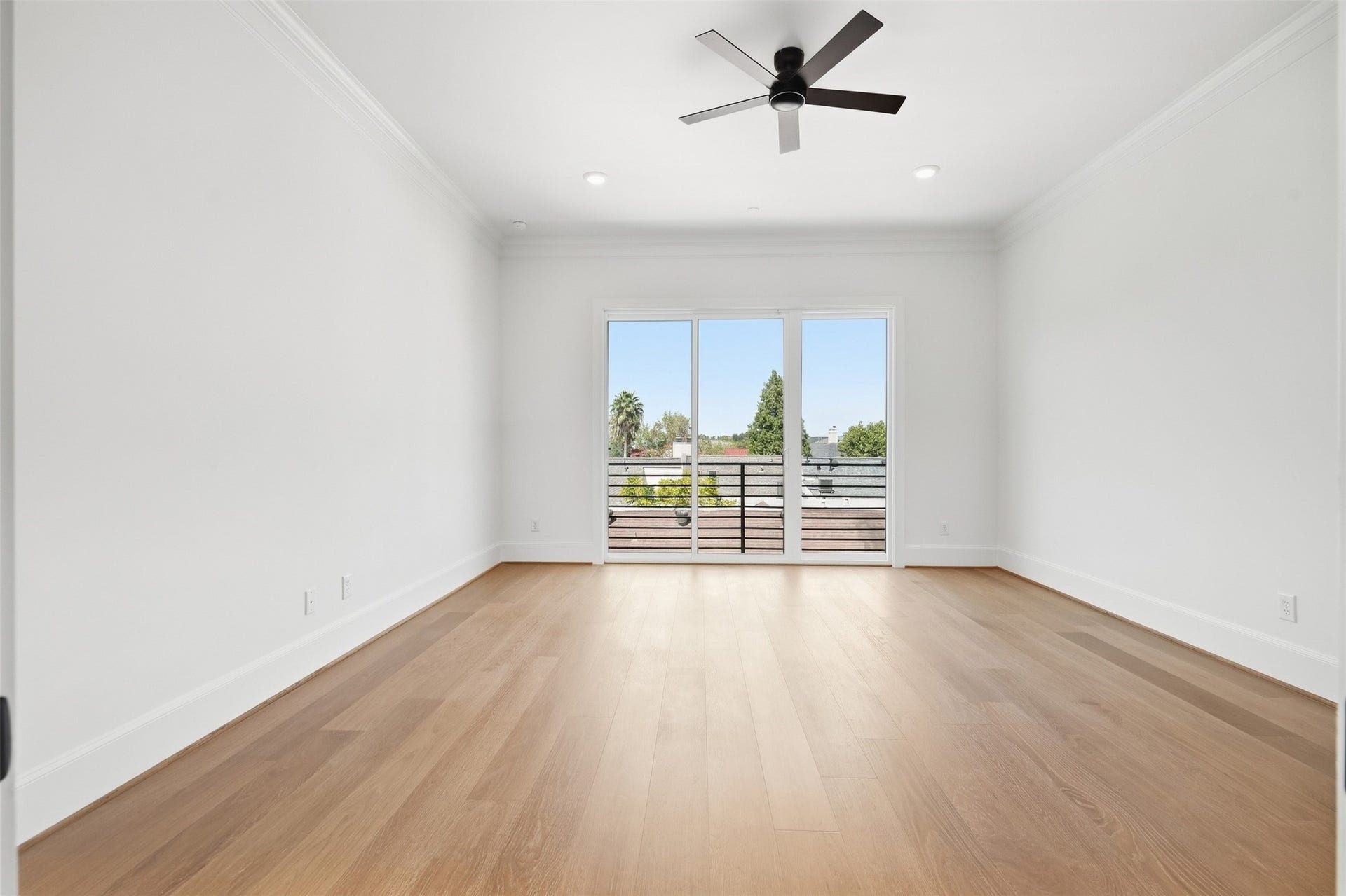 2111 Nantucket Drive, #D, Houston, TX 77057 This spacious primary bedroom features a large glass doors that bring in natural light.