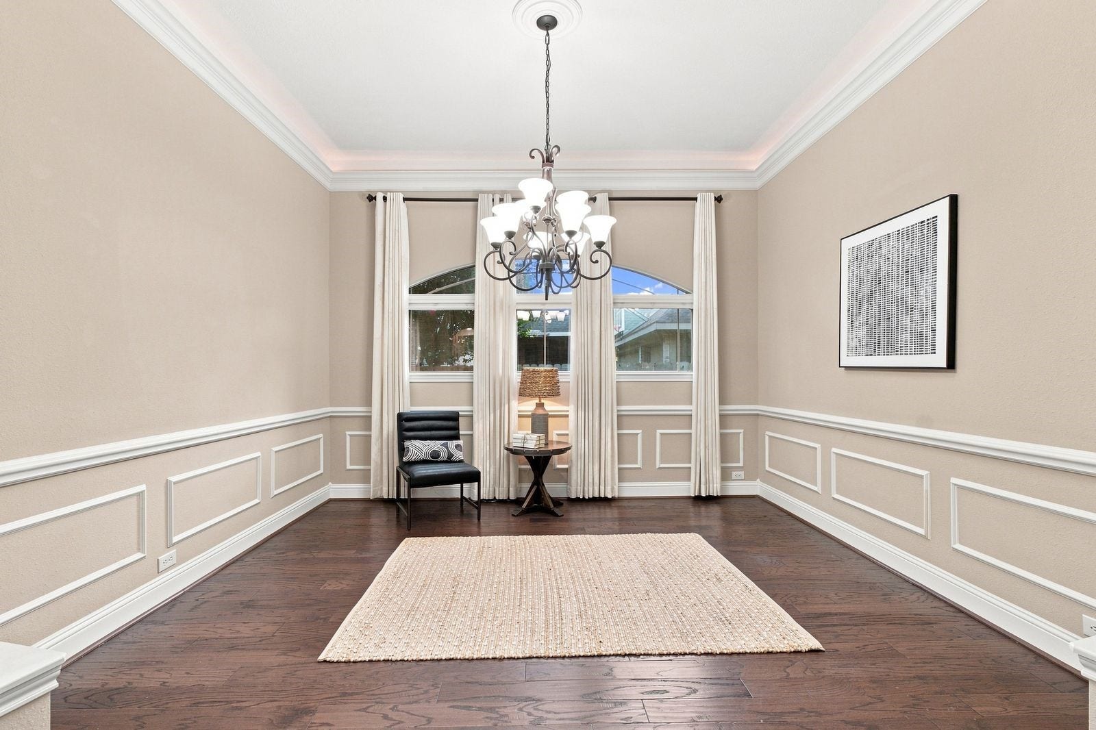 Dining room features cove lighting, a chandelier and beautiful ceiling medallion.