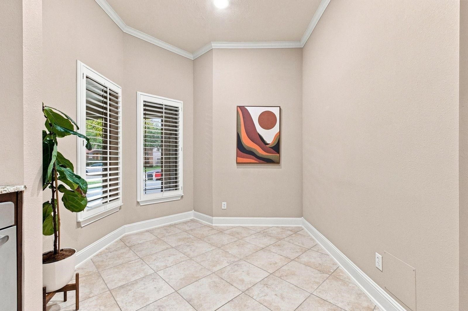 Breakfast nook with plantation shutters and oversized  windows.