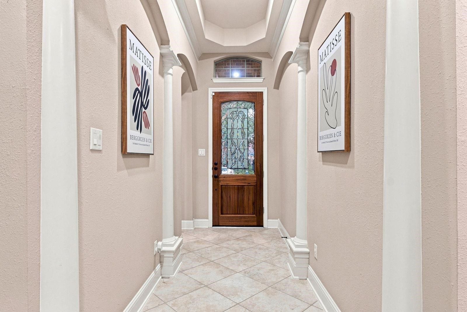 Beautiful recently refinished front door with ornate glass lets tons of natural light in.