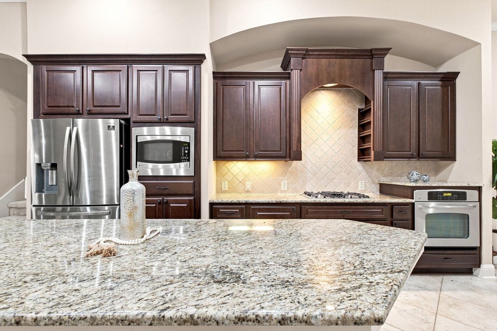 The kitchen is the true center of the home and features under cabinet lighting and more cabinet space than you can ever use.