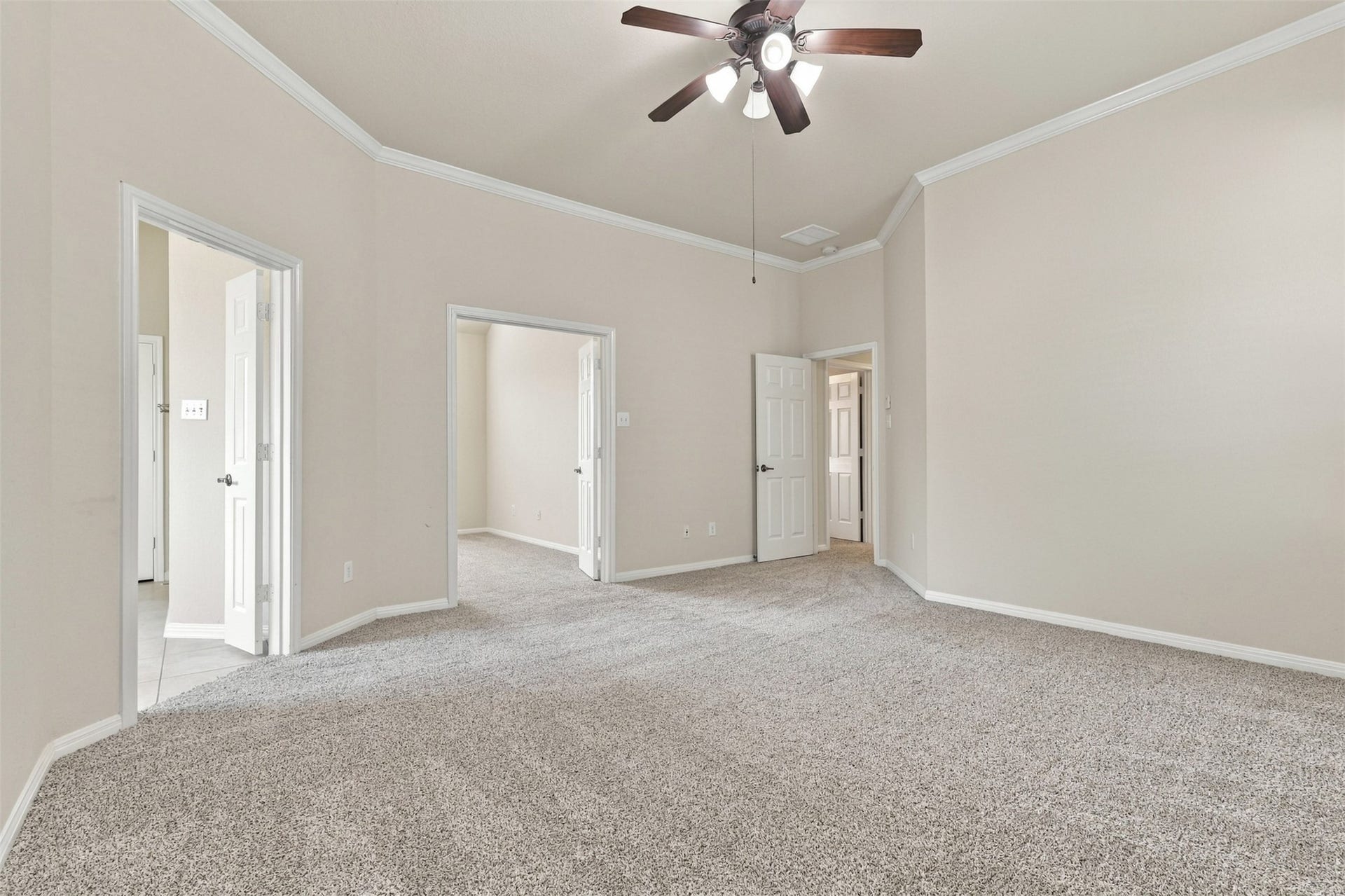6414 Pinyon Trail Drive, Spring, TX 77389 Spacious primary room with plush carpeting, neutral walls, and a ceiling fan, with views into the flex room.