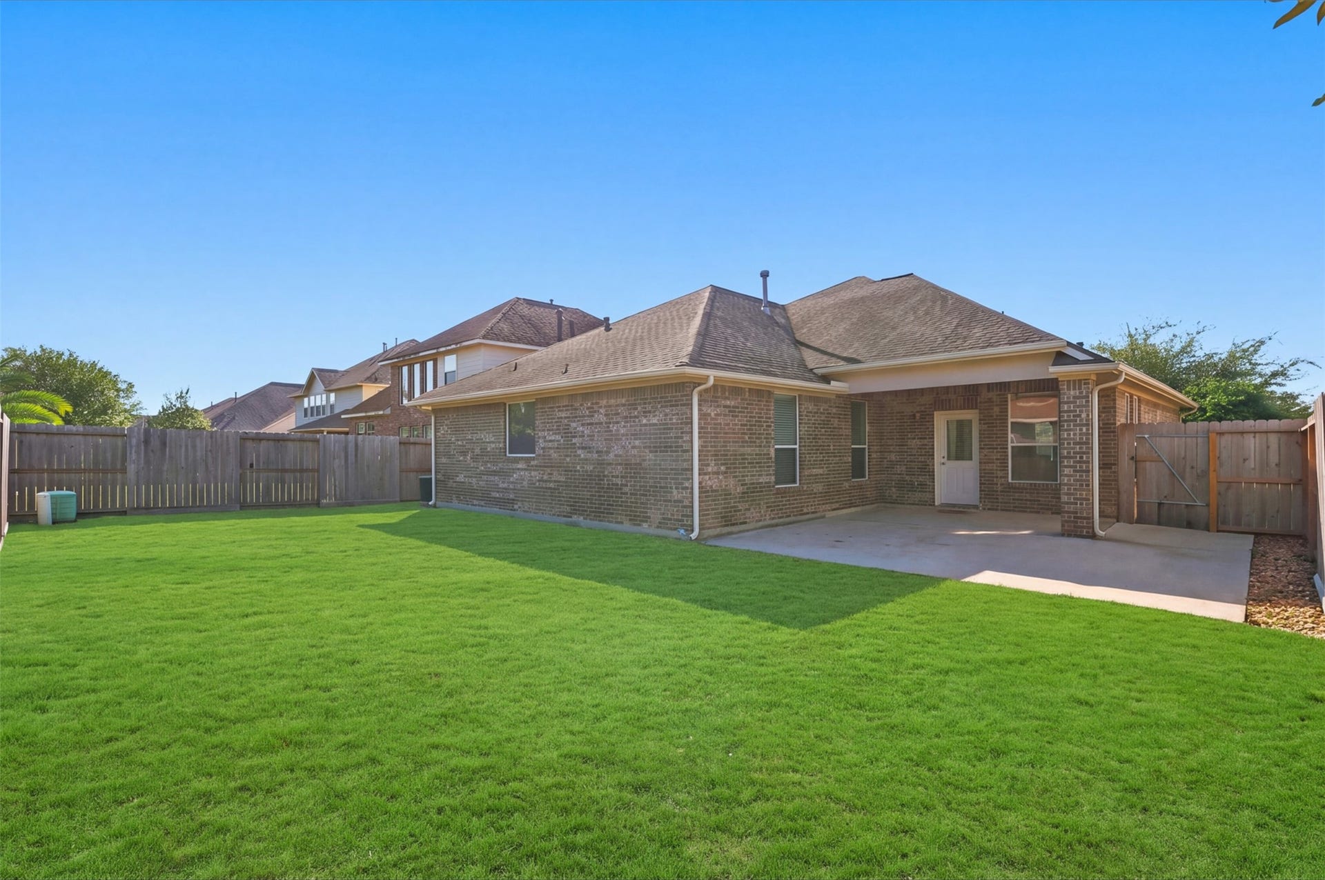 6414 Pinyon Trail Drive, Spring, TX 77389 Expansive backyard with a lush lawn and a cozy patio area, perfect for outdoor gatherings and relaxation.