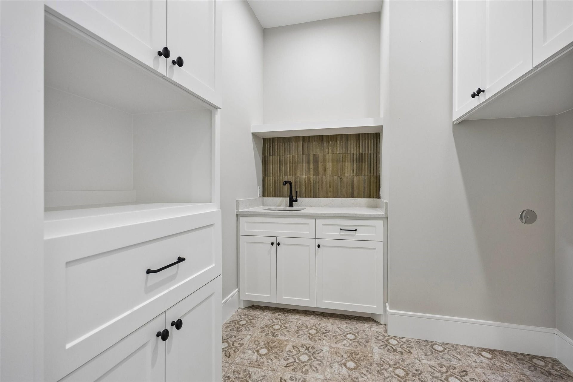 6107 Lake Street, West University Place, TX 77005 A large well designed laundry room includes hamper and cabinets for all the essentials...