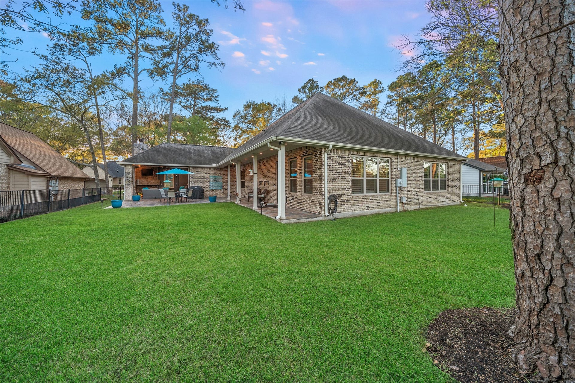This backyard is like no other! Fully fenced and a cozy covered area to gather around the fireplace and relax.