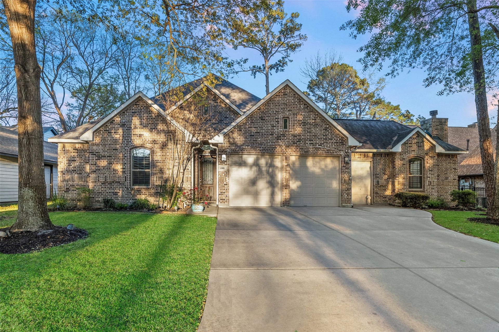 Beautifully shaded home nested on the April Sound Golf Course. 2 car garage PLUS a golf cart garage.