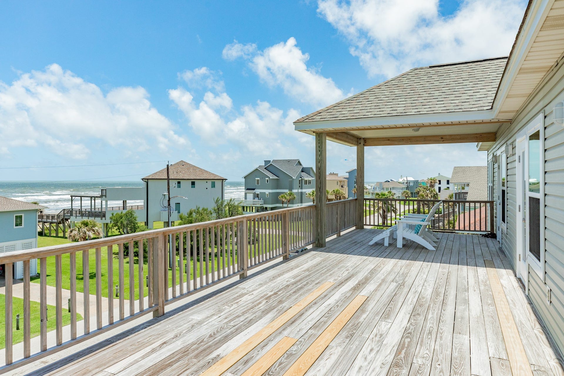 18502 E De Vaca, Galveston, TX 77554 Just outside the upstairs primary suite, there is a nice, covered area to take in the sights & gulf breezes while in the shade.