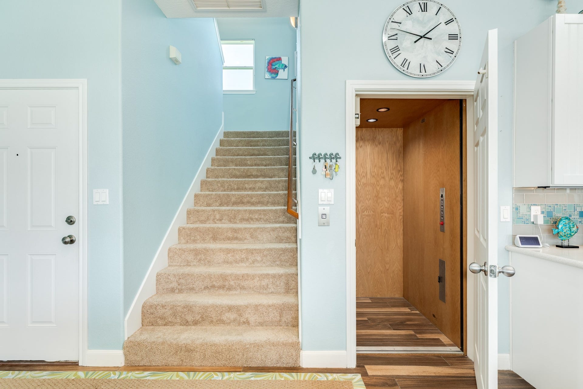 18502 E De Vaca, Galveston, TX 77554 And now to the second floor of the home, you may either go up the carpeted staircase or via the elevator.