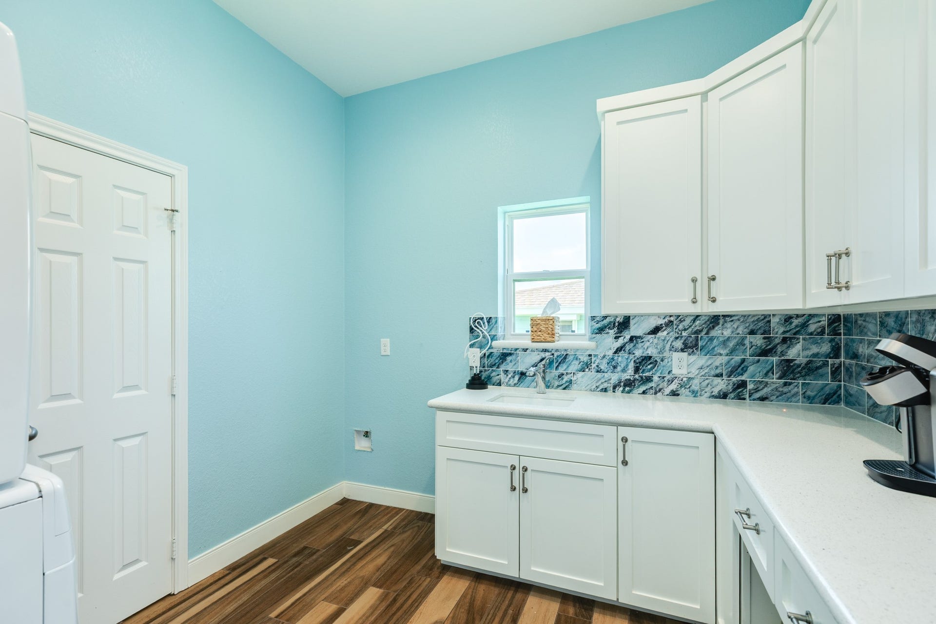 18502 E De Vaca, Galveston, TX 77554 Utility room is spacious at 9 x 9, with storage above and below countertops.