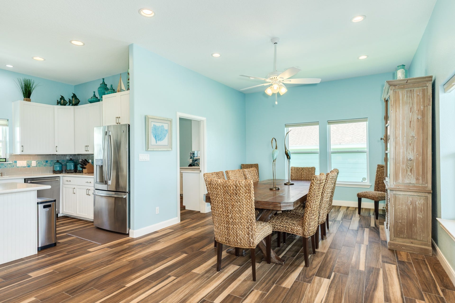 18502 E De Vaca, Galveston, TX 77554 Currently, the dining area is arranged to seat 8 with plenty of additional room as you can see. The open doorway to the left leads to the utility room and spacious walk in pantry.