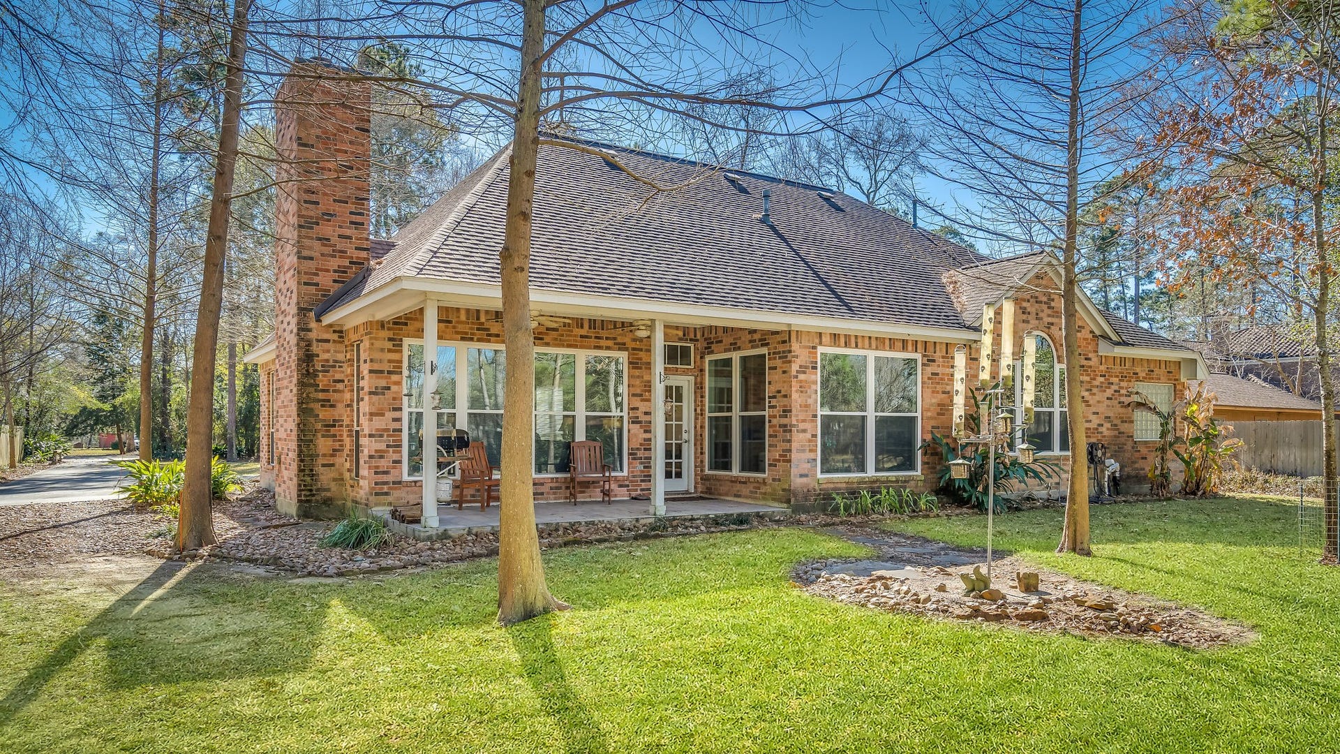 2500 Centerline Road, Conroe, TX 77384 Unwind on the inviting covered patio of this charming brick home, perfect for relaxing evenings surrounded by nature