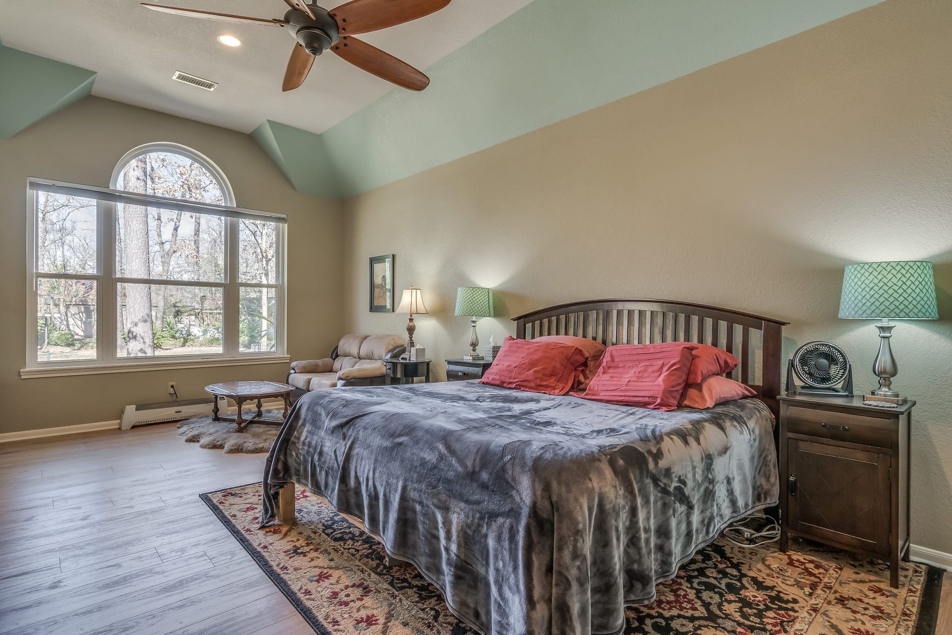 2500 Centerline Road, Conroe, TX 77384 Experience serene comfort in this primary suite featuring a ceiling fan and a large window with picturesque backyard views