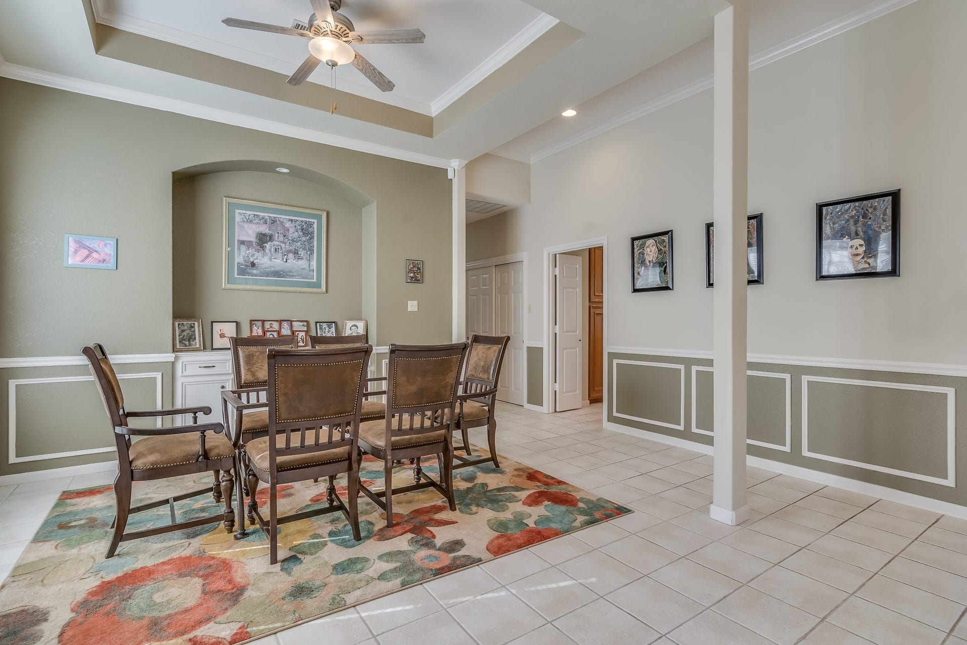 2500 Centerline Road, Conroe, TX 77384 Discover elegance in this formal dining area, featuring a ceiling fan, lighted art niche, stylish trim, and tiled flooringperfect for memorable gatherings