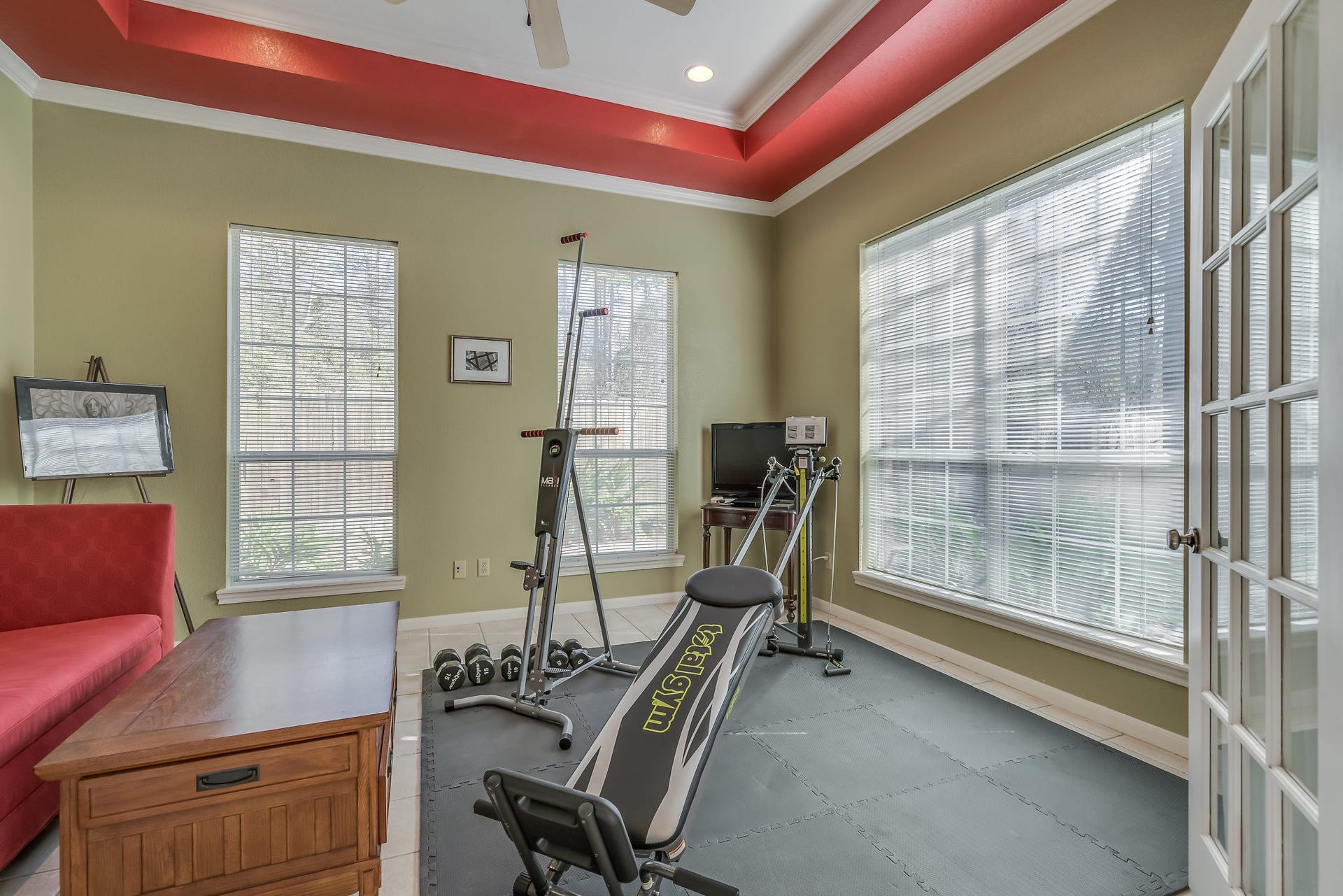 2500 Centerline Road, Conroe, TX 77384 Discover your perfect space with this versatile room featuring elegant French doors, ceiling fan, and tile flooringideal for a home office or workout space