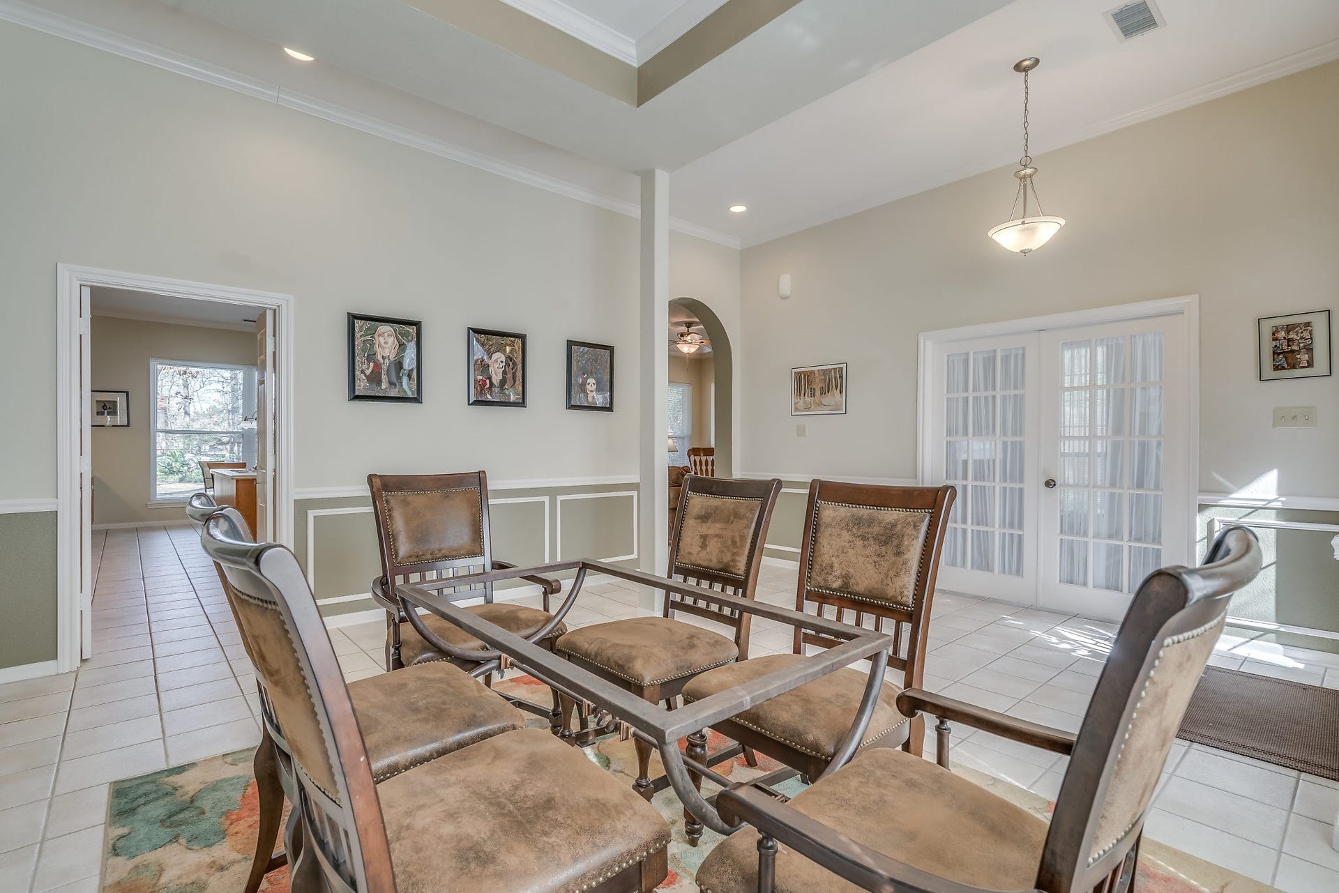 2500 Centerline Road, Conroe, TX 77384 Discover a bright and inviting dining area and foyer seamlessly leading to the kitchen and family room, with a cozy study tucked behind elegant French doors