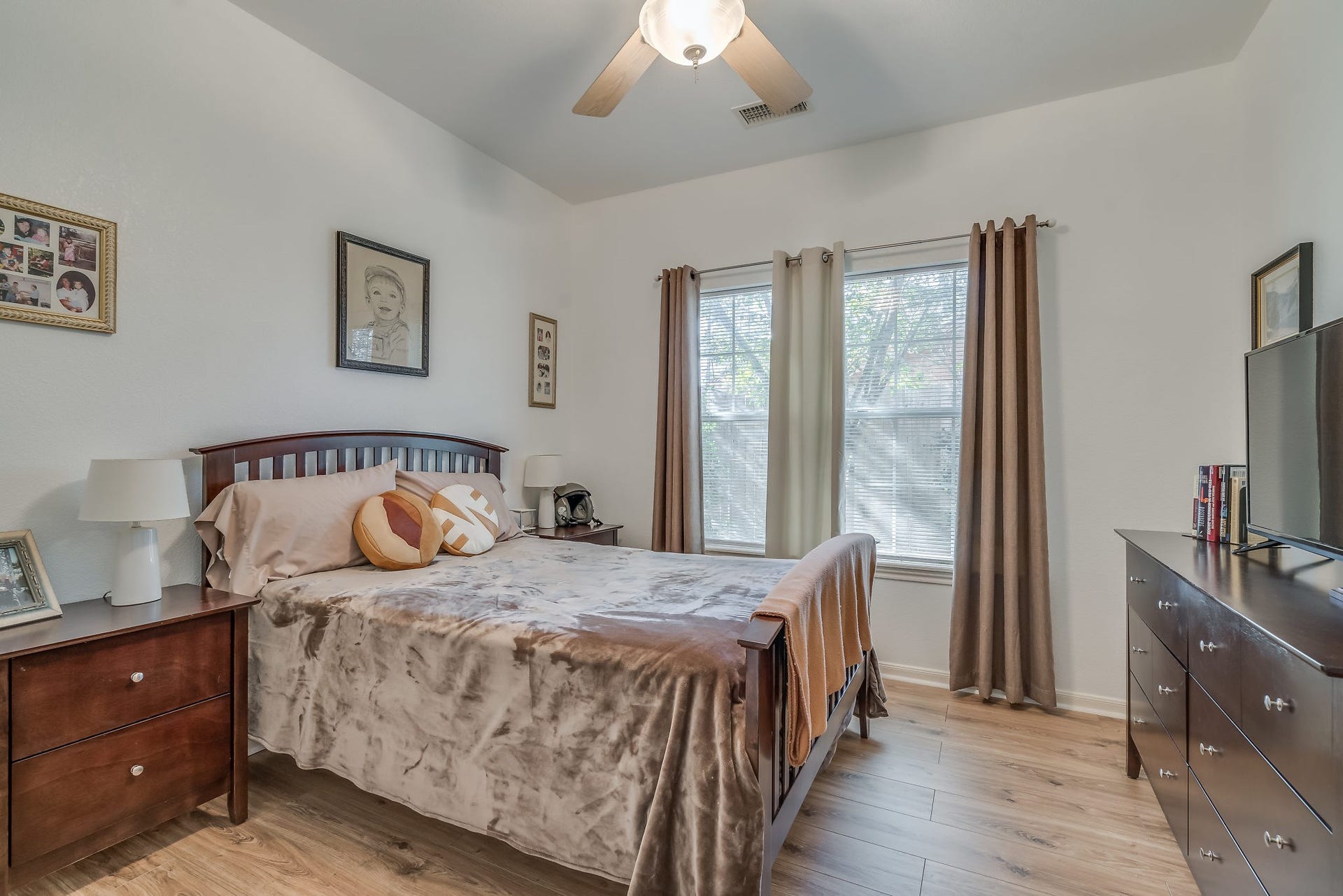 2500 Centerline Road, Conroe, TX 77384 Experience comfort and style in Bedroom 2, featuring ceiling fan and laminate wood floors