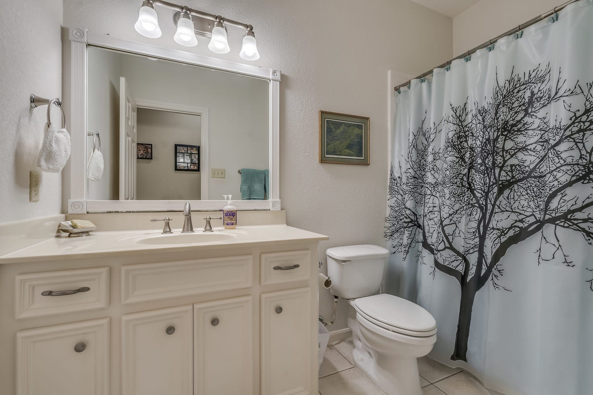 2500 Centerline Road, Conroe, TX 77384 This charming guest bathroom features elegant tile flooring and a convenient tub/shower combo, with an additional half bath (not pictured) off the dining area providing extra convenience for guests