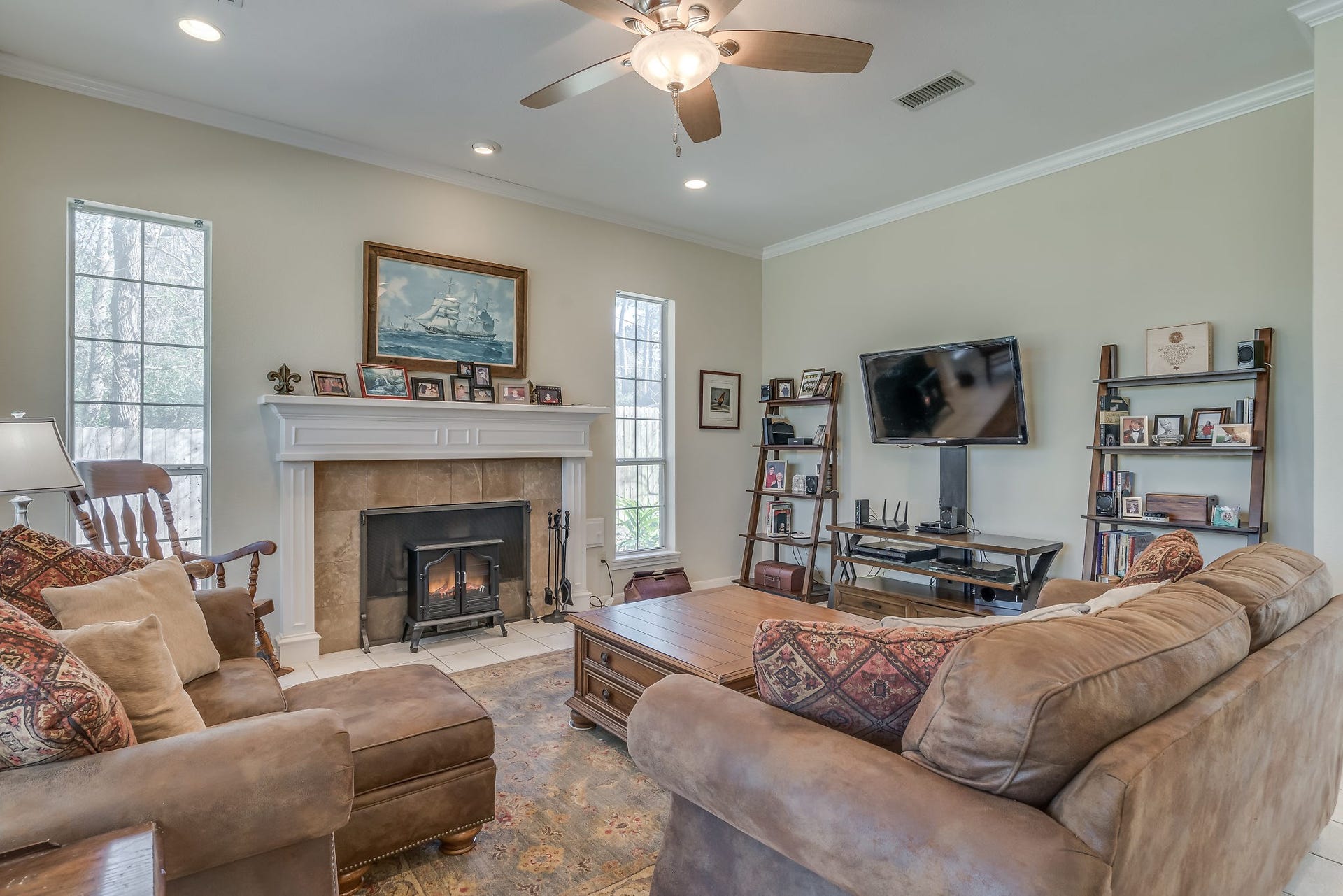2500 Centerline Road, Conroe, TX 77384 Discover the perfect blend of elegance and comfort in this charming family room, featuring tiled flooring, ceiling fan, crown molding, and cozy wood-burning fireplace with gas connections
