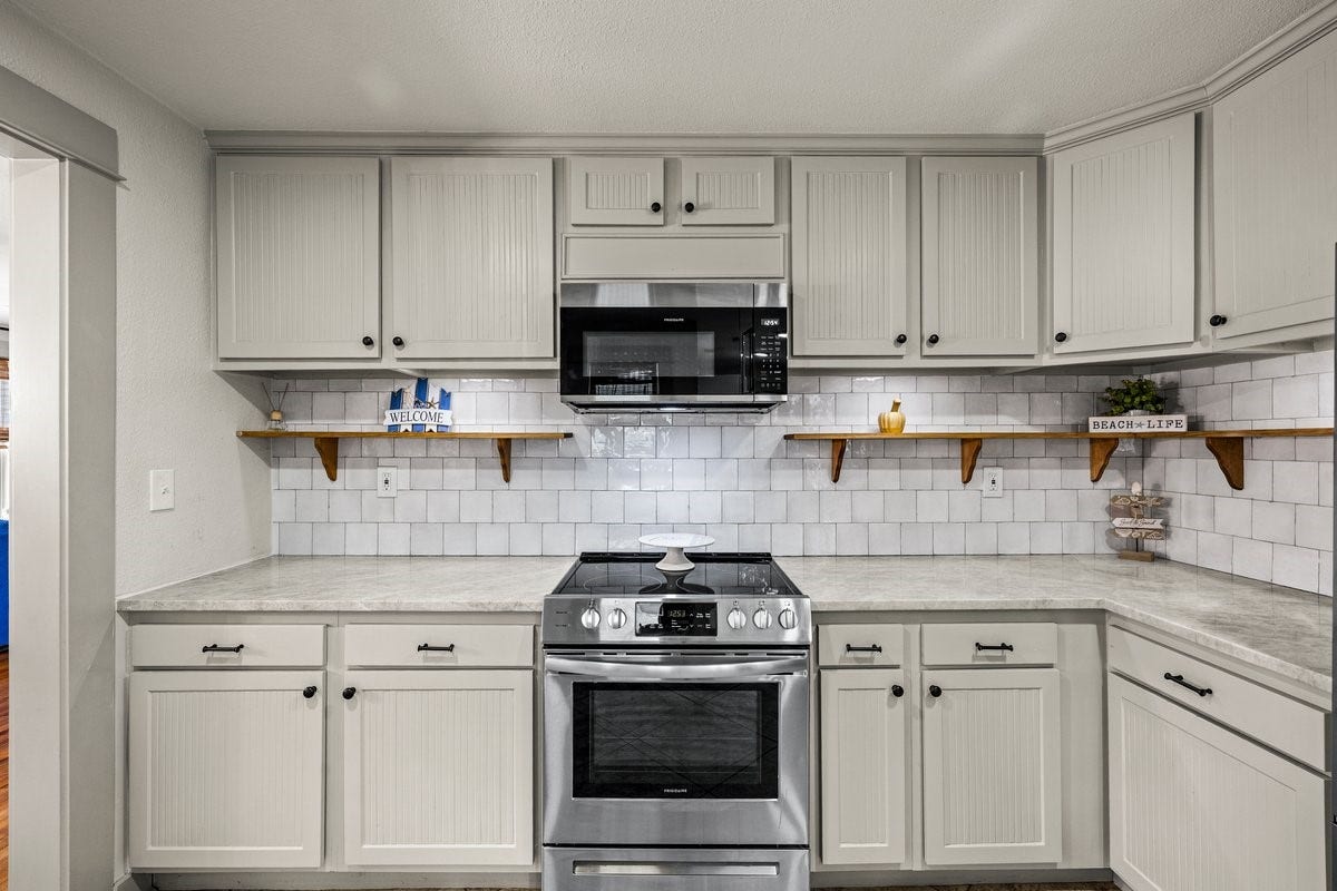 1414 29th Street, Galveston, TX 77550 The kitchen features gorgeous quartzite countertops and stylish open shelving