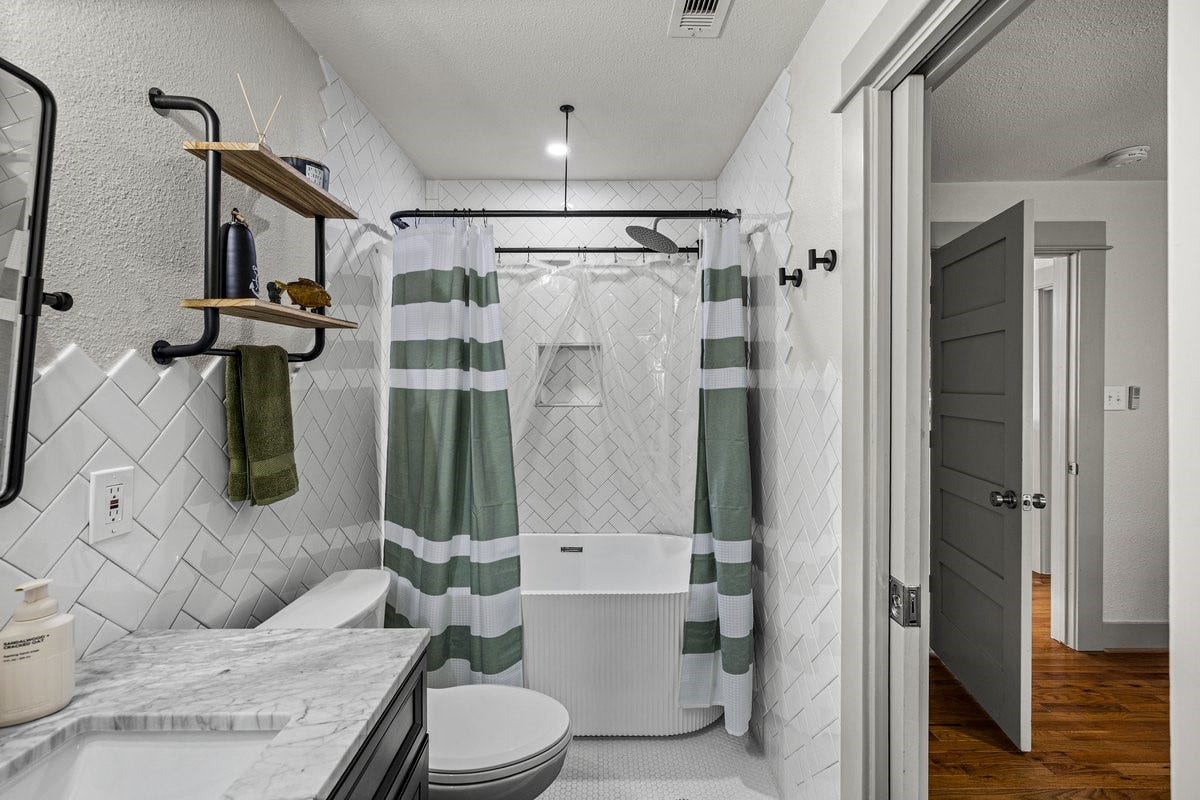 1414 29th Street, Galveston, TX 77550 Beautifully remodeled primary bathroom #2 in a Galveston home.