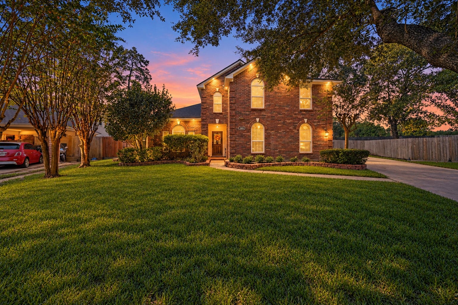 1806 Kensington Park Circle, Spring, TX 77386 Elegant front exterior beneath sunset skies.