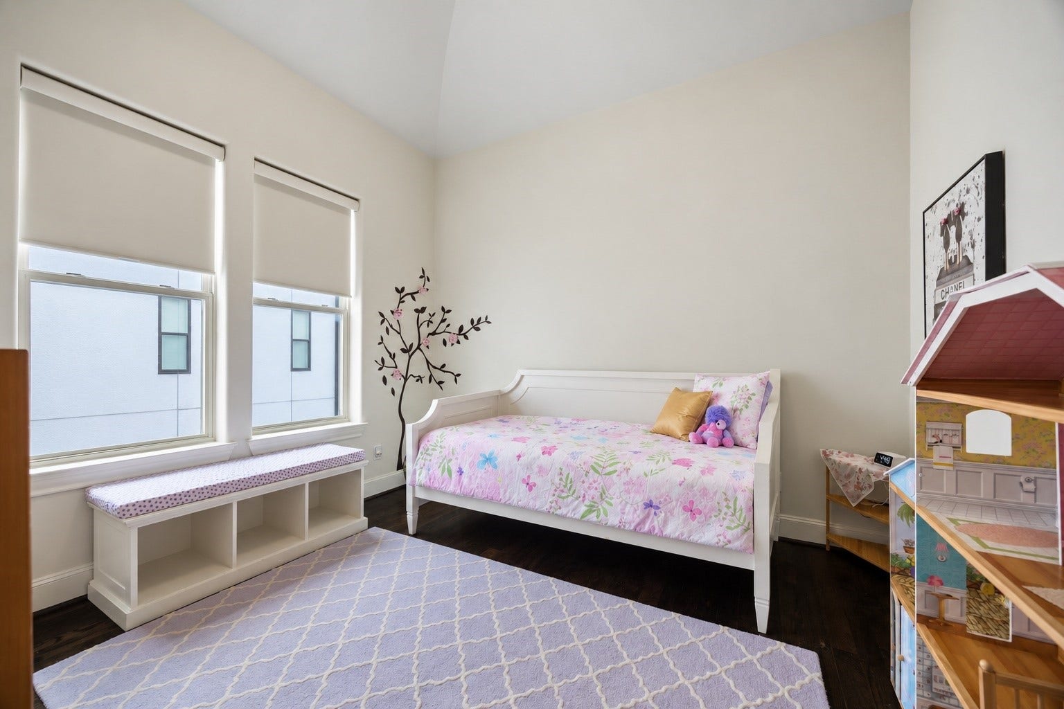 2725 Cohn Garden, Houston, TX 77007 Vaulted ceilings and paired windows bring natural light into this secondary bedroom, while dark hardwood floors add warmth and contrast.