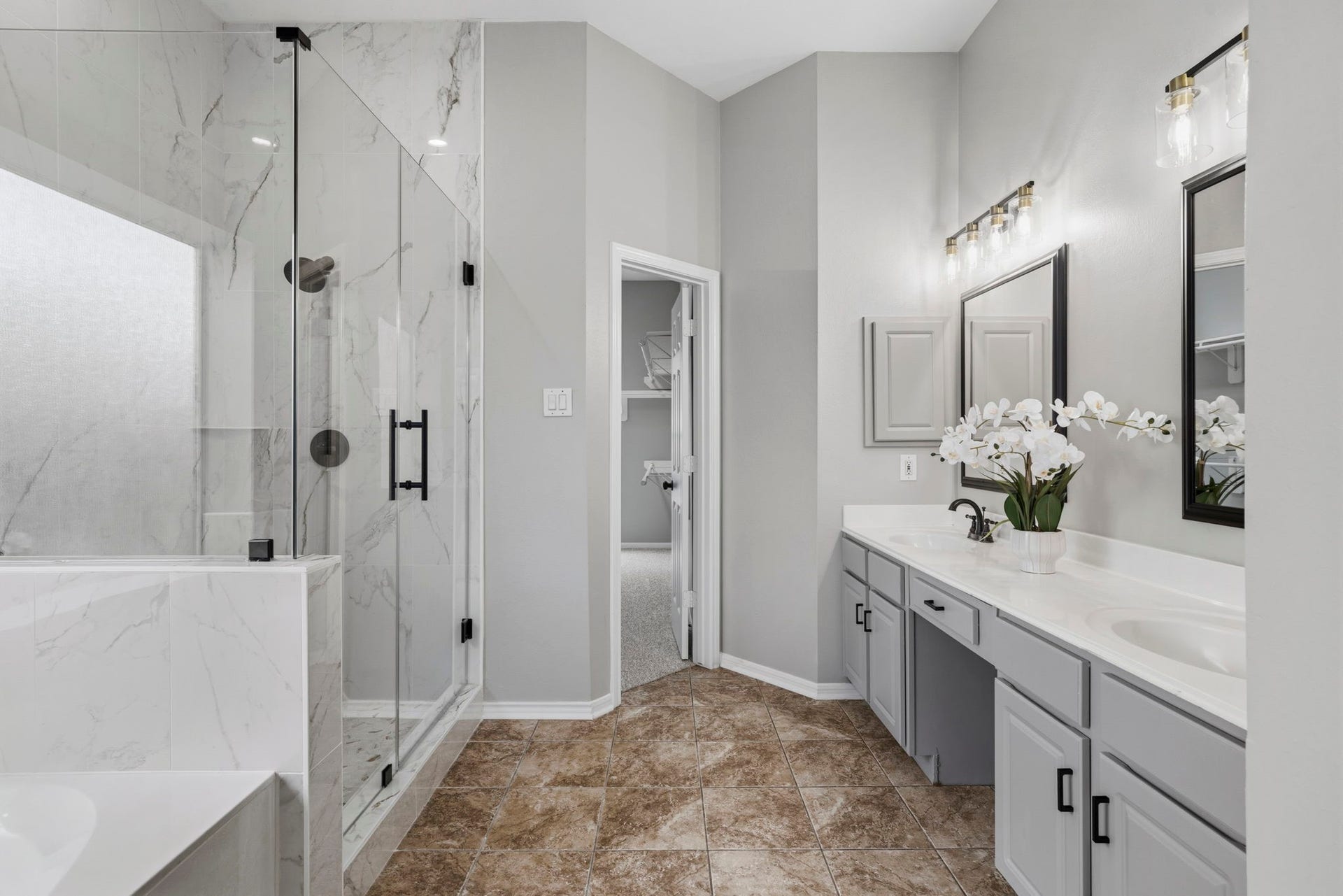 3427 Powell Way, Missouri City, TX 77459 Elegant primary bath with dual vanities and a glass-enclosed shower.