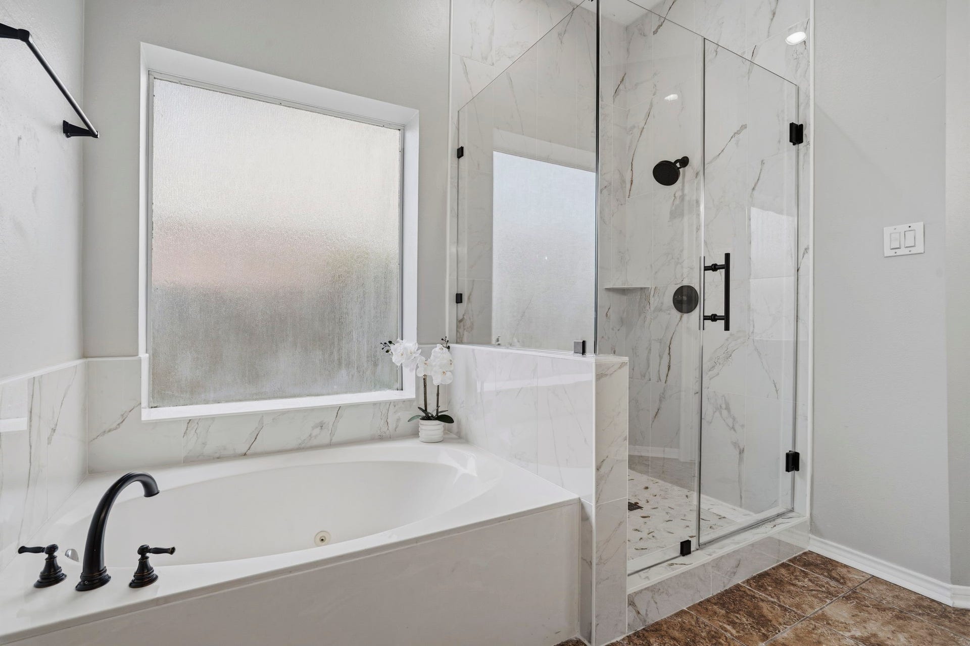 3427 Powell Way, Missouri City, TX 77459 Spa-inspired bath with a soaking tub and glass-enclosed shower.