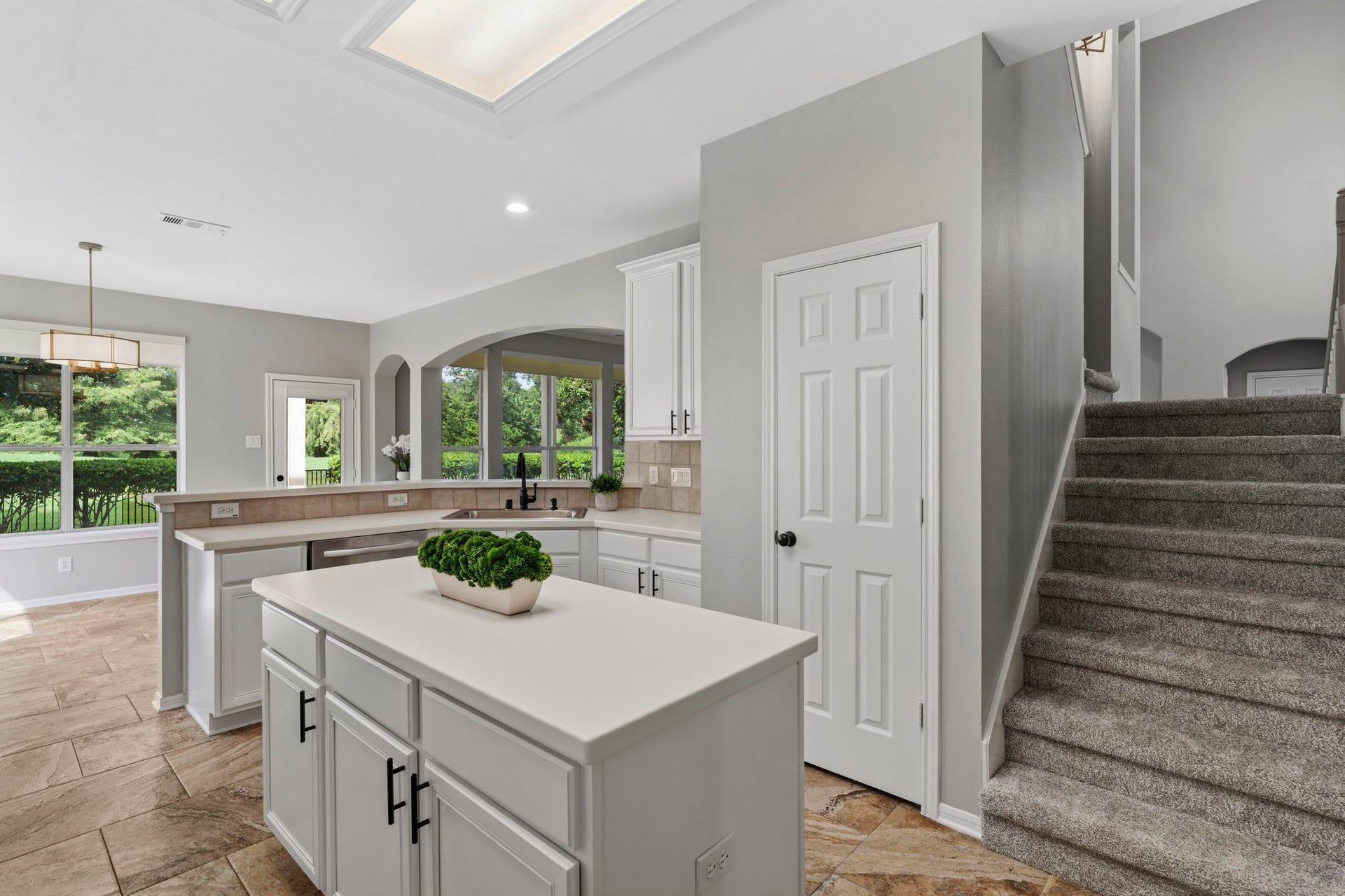 3427 Powell Way, Missouri City, TX 77459 Open kitchen with a center island and convenient stairway access.