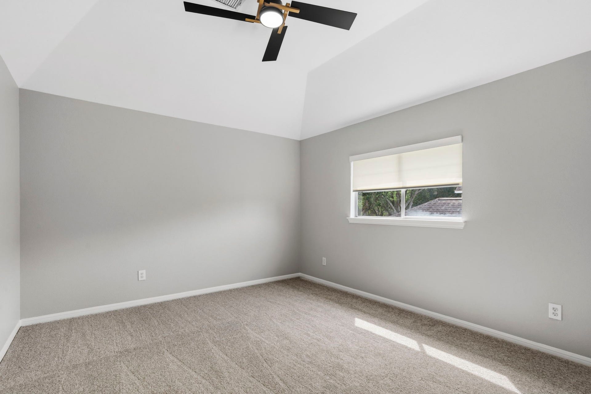 3427 Powell Way, Missouri City, TX 77459 Comfortable bedroom with a vaulted ceiling and natural light.