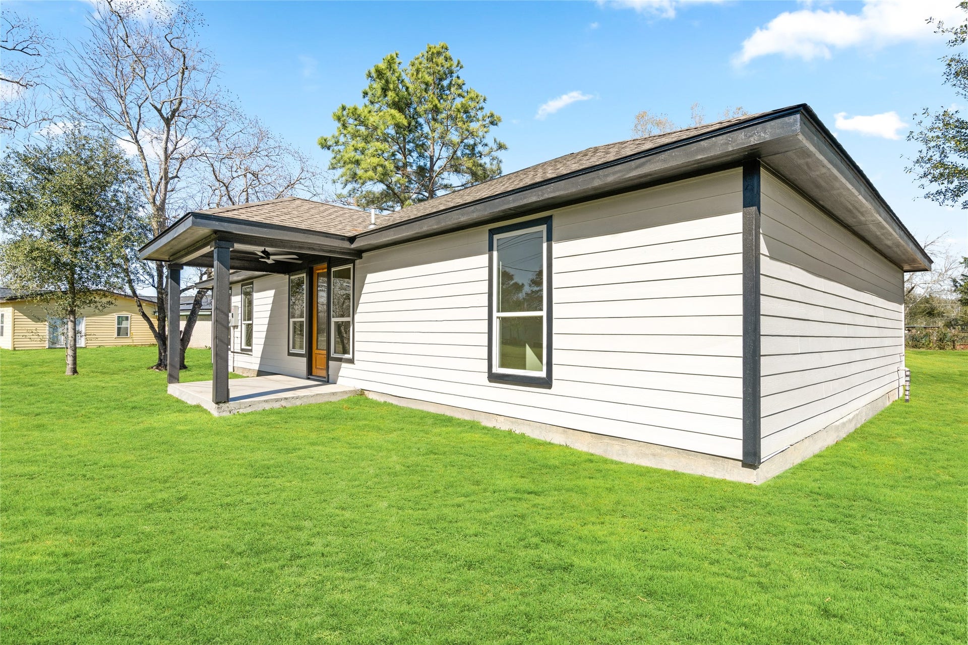 Exterior rear view showcasing the homes modern lines and expansive backyardperfect for entertaining or relaxing outdoors.