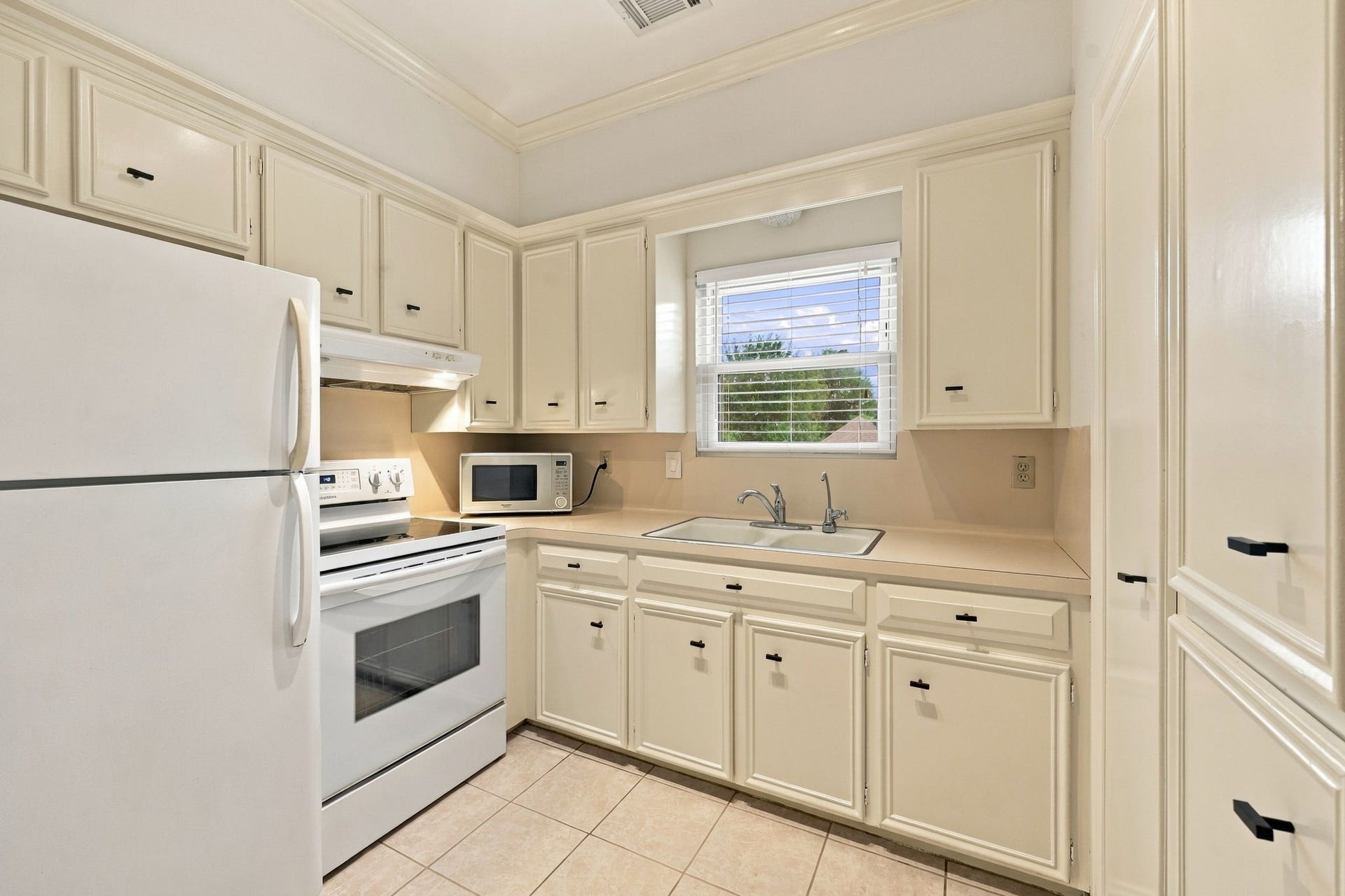 1430 Stependale Drive, Katy, TX 77450 Garage Apt Full Kitchen featuring white cabinetry, ample cabinet storage, a window above the sink, and a functional layout.