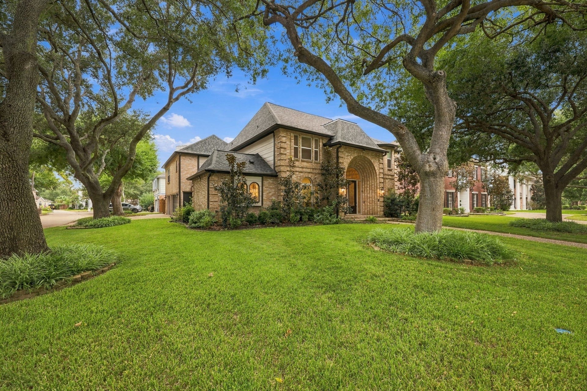 1430 Stependale Drive, Katy, TX 77450 Attractive two-story brick faade with a welcoming walkway, arched entry, and established landscaping.