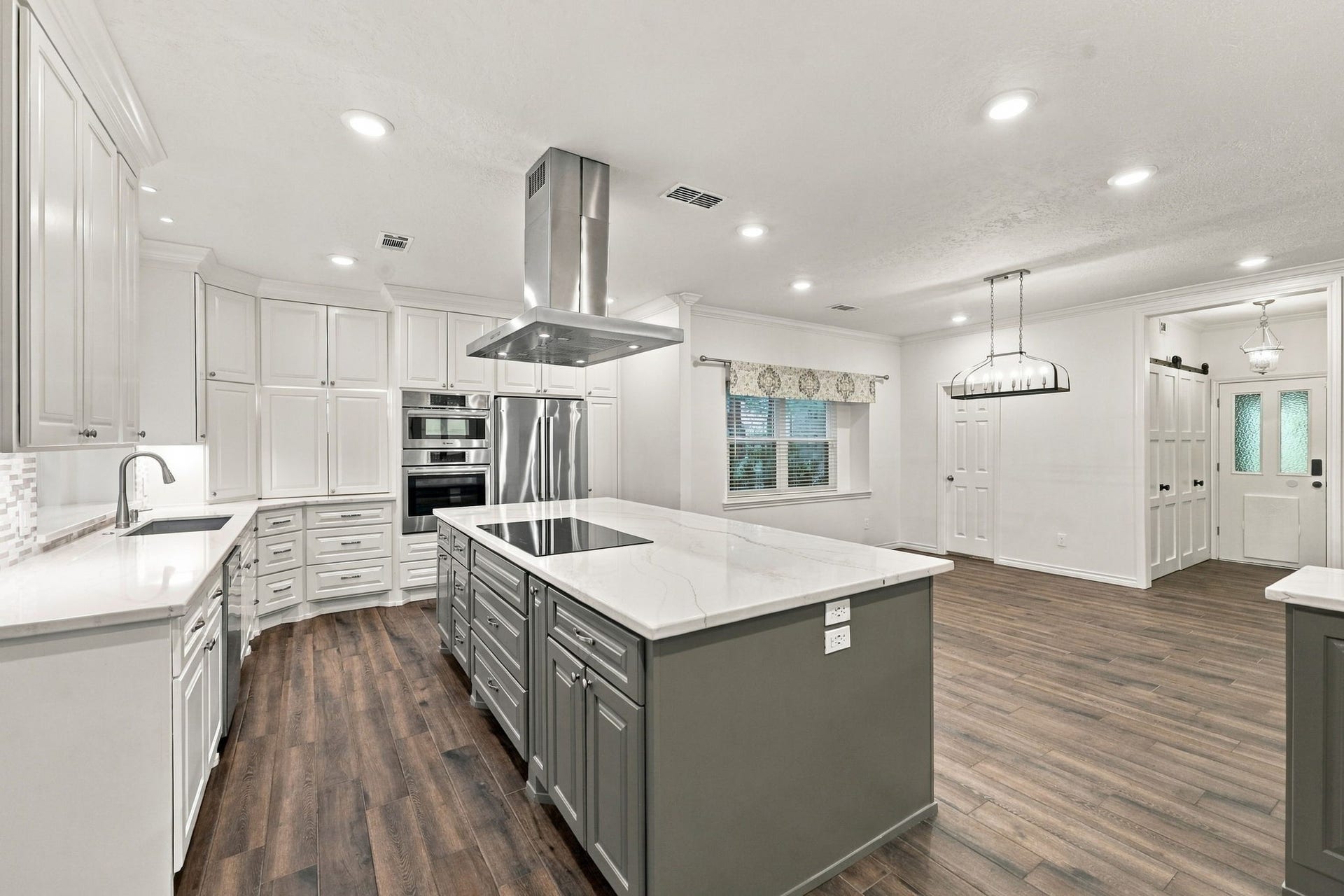 1430 Stependale Drive, Katy, TX 77450 Expansive kitchen with generous counter space, a central island, stainless steel appliances, and open living areas.
