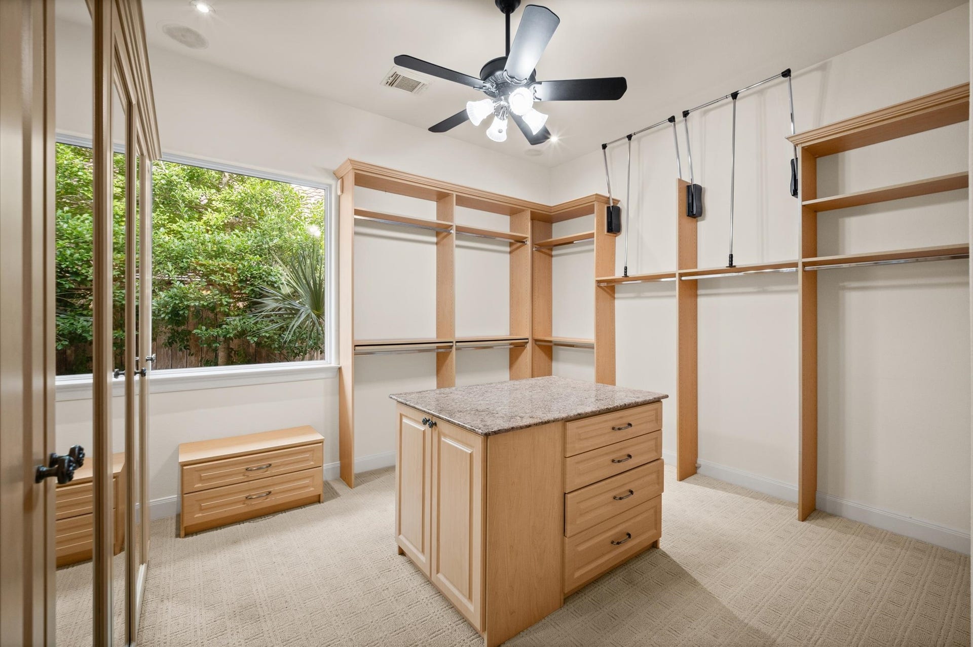 3010 Bonnebridge Way Boulevard, Houston, TX 77082 Originally a bedroom, this beautifully transformed space now serves as the largest of three primary closets, offering exceptional storage, a center island, and the feel of a private dressing room