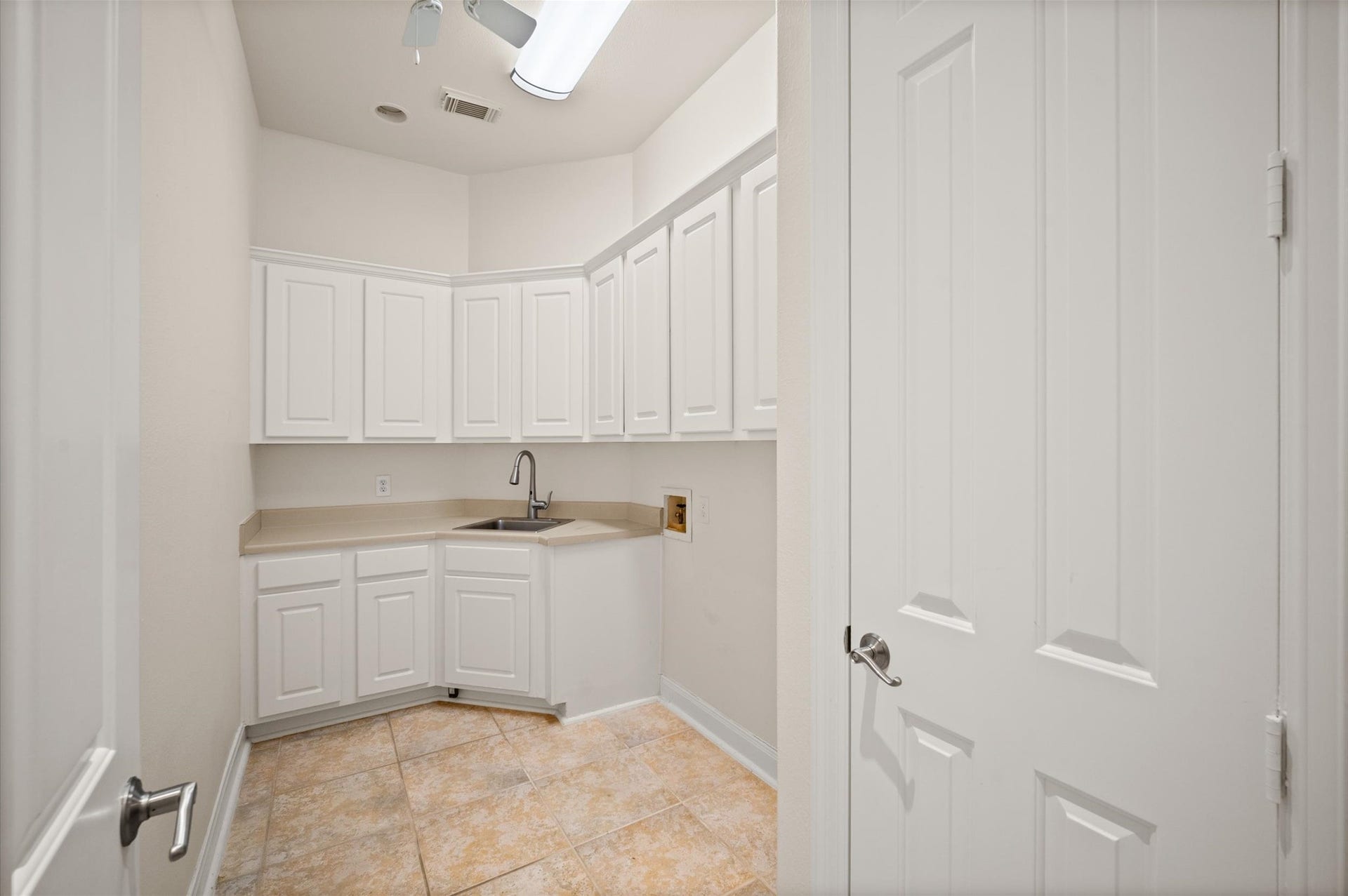 3010 Bonnebridge Way Boulevard, Houston, TX 77082 A conveniently located laundry room offers ample cabinetry, generous workspace, and a utility sink for added everyday functionality.