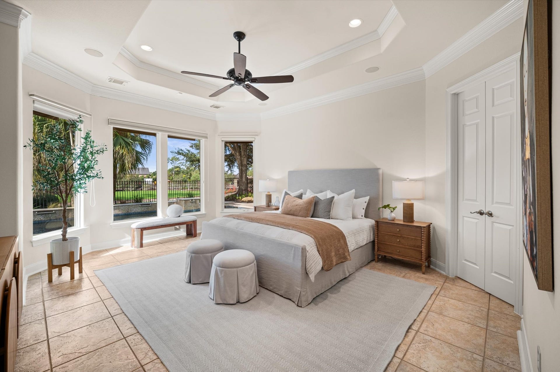 3010 Bonnebridge Way Boulevard, Houston, TX 77082 The serene first floor primary suite is filled with natural light, with a graceful tray ceiling and expansive windows framing peaceful views of the backyard and golf course beyond.