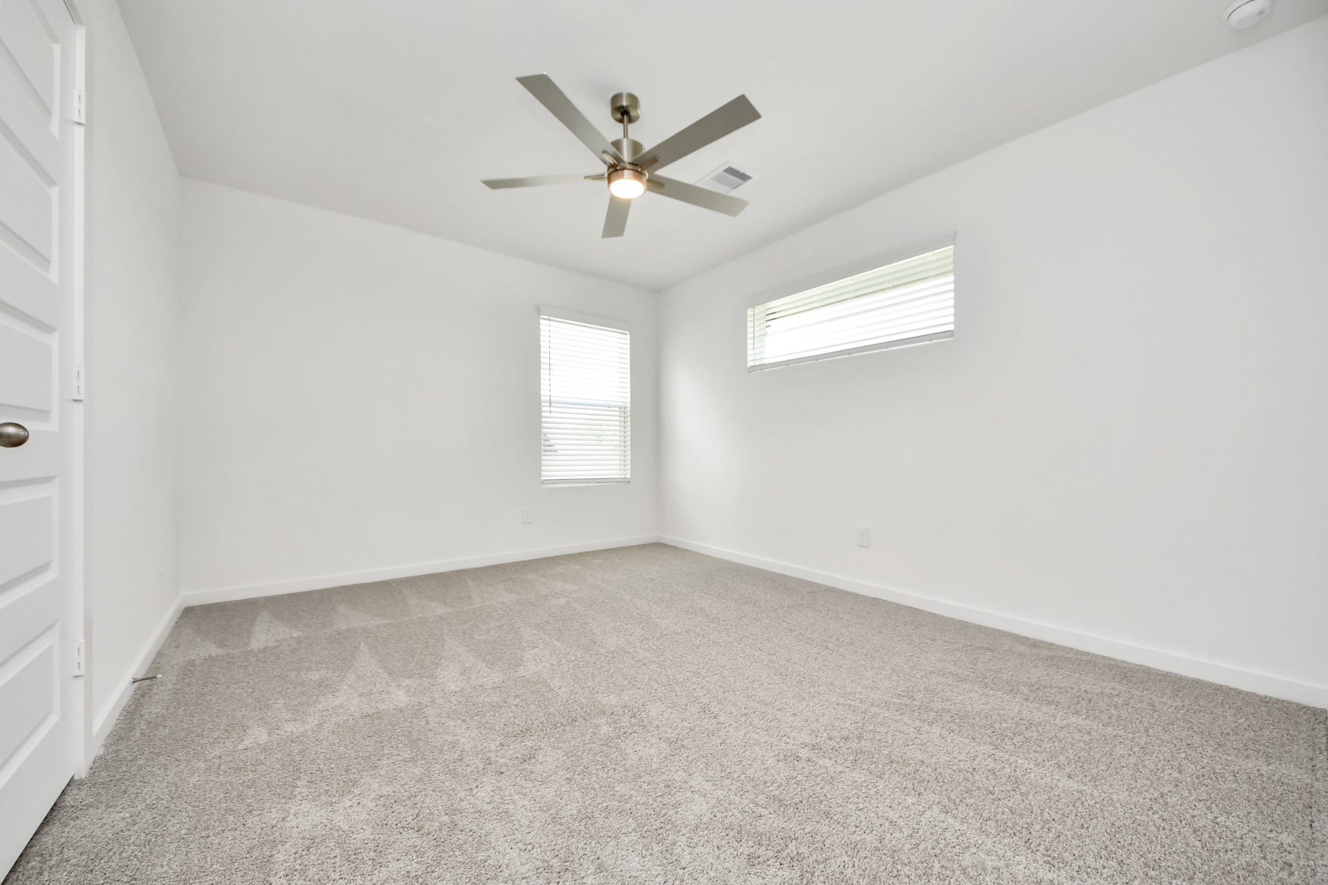 5822 Madison Trail Drive, Richmond, TX 77469 Secondary bedroom features plush carpeting, large windows that let in plenty of natural light, bright paint, and spacious closets. Sample photo of completed home with similar floor plan. Actual colors and selections may vary.