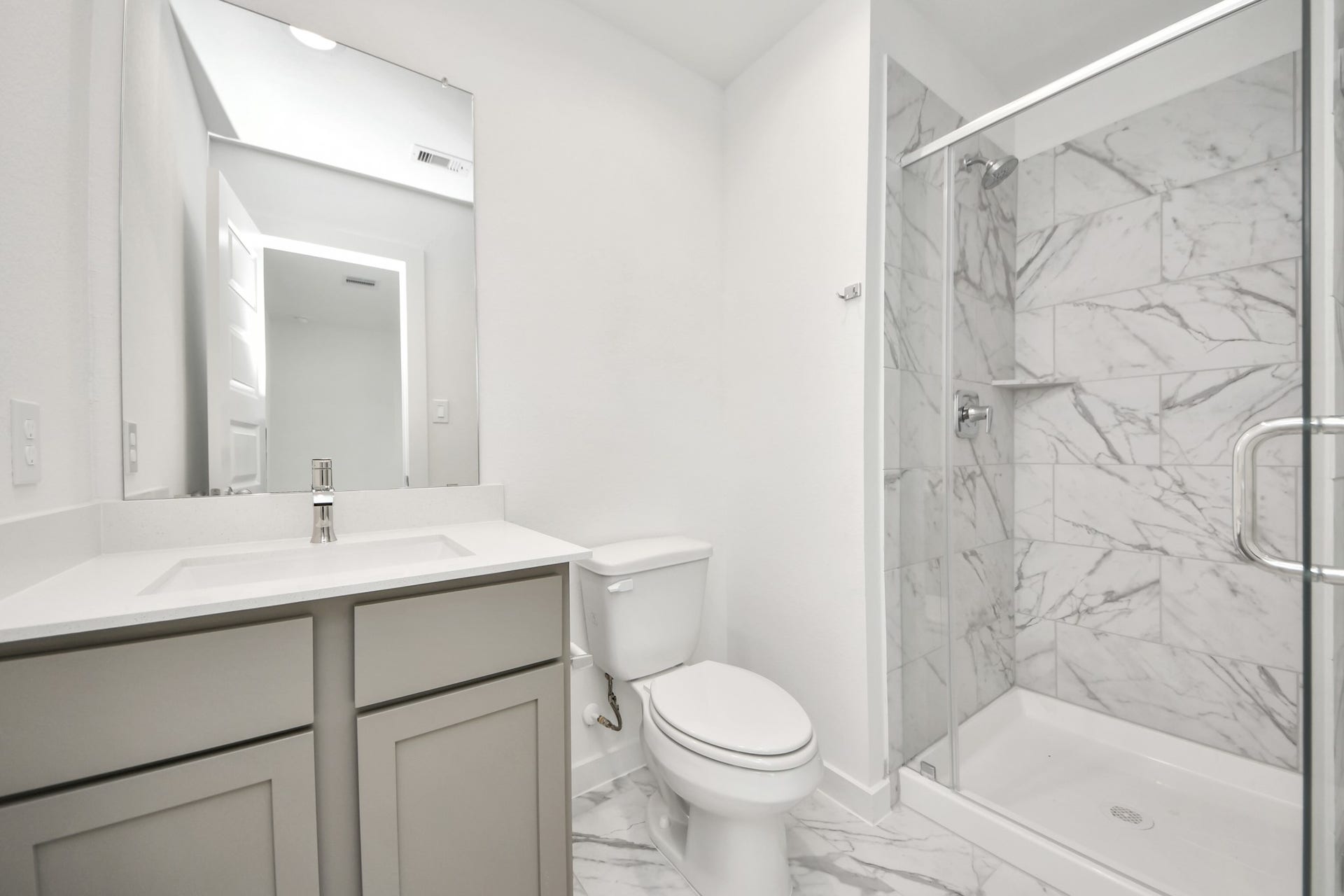 5822 Madison Trail Drive, Richmond, TX 77469 Secondary bath features tile flooring, walk-in shower with tile surround, light stained wood cabinets, beautiful light countertop. Sample photo of completed home with similar floor plan. Actual colors and selections may vary.