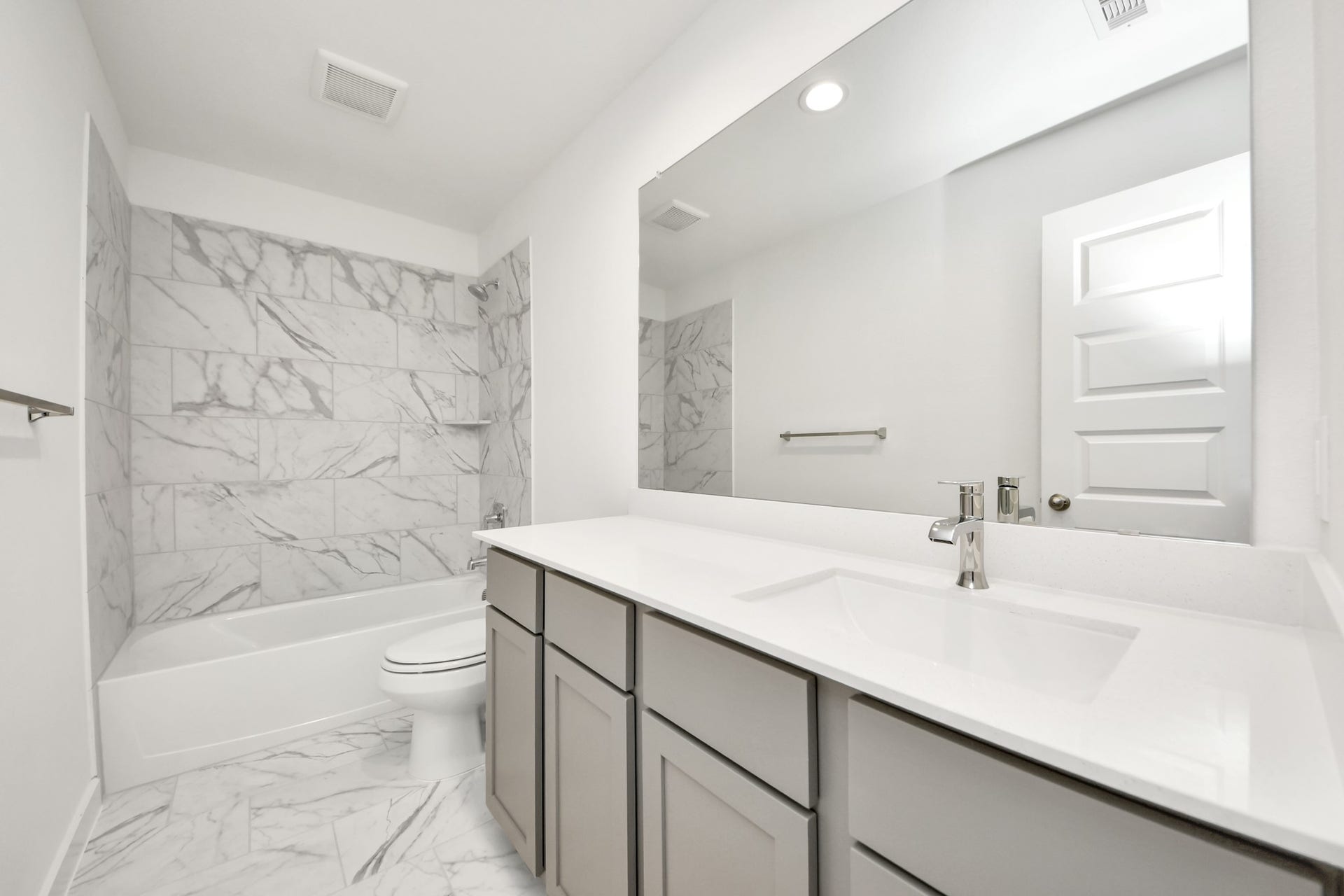 5822 Madison Trail Drive, Richmond, TX 77469 Secondary bath features tile flooring, bath/shower combo with tile surround, light stained wood cabinets, beautiful light countertop. Sample photo of completed home with similar floor plan. Actual colors and selections may vary.